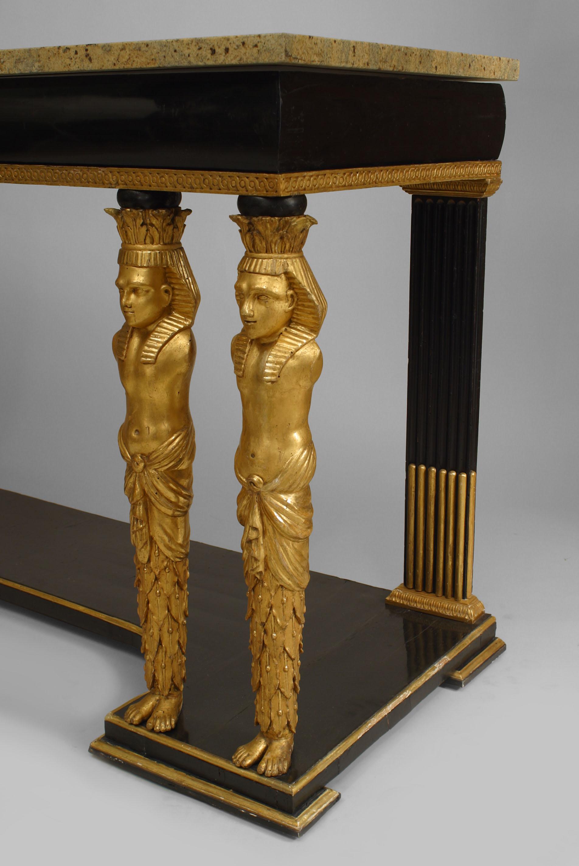 Continental Austrian Empire-style (circa 1800) ebonized & gilt trimmed console table with 4 gilt carved classical Egyptian figural front supports on a platform base with a marble top.
