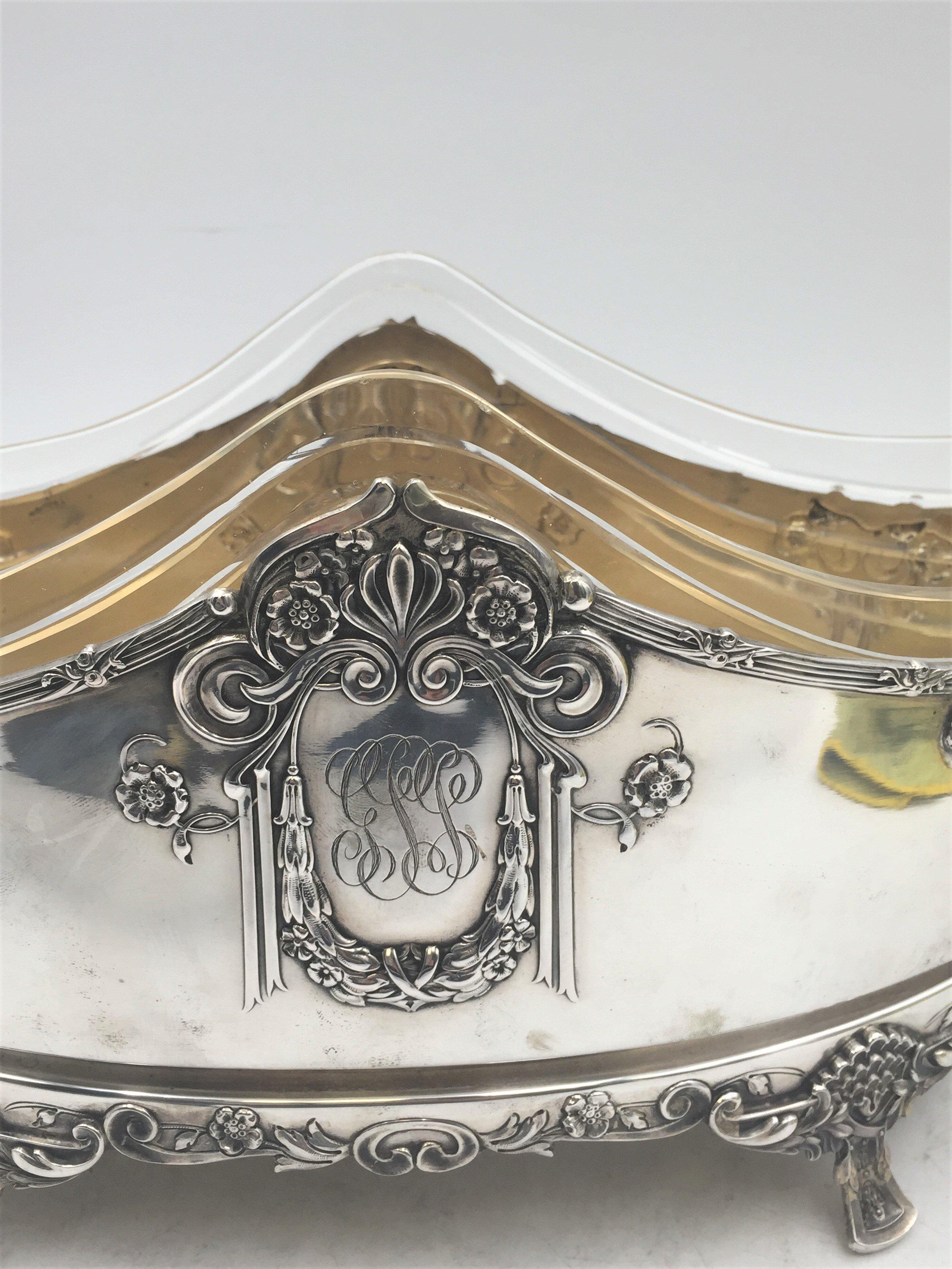 Austrian silver centerpiece / two-handled bowl with gilt interior in Art Nouveau design. Expertly constructed in Olomouc/Olmutz (1872-1921). Its design uses beautiful floral and ornamental motifs in raised relief. Comes with a glass insert, which