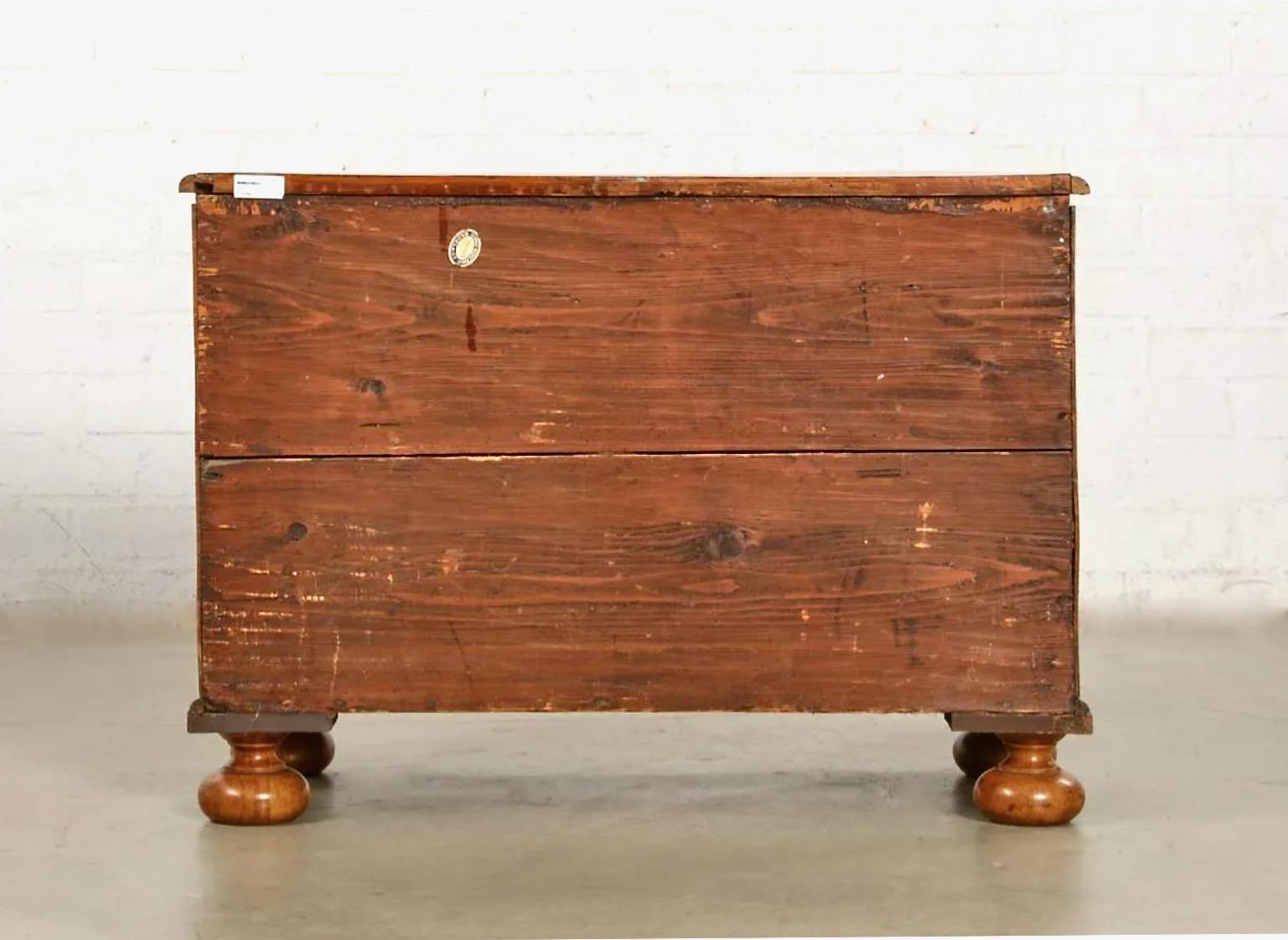 This is a good example of a German serpentine-front inlaid walnut and Circassian walnut chest of drawers that dates to the first half of the 18th century. The smaller proportions of this chest make it comparable to an english bachelors chest. The