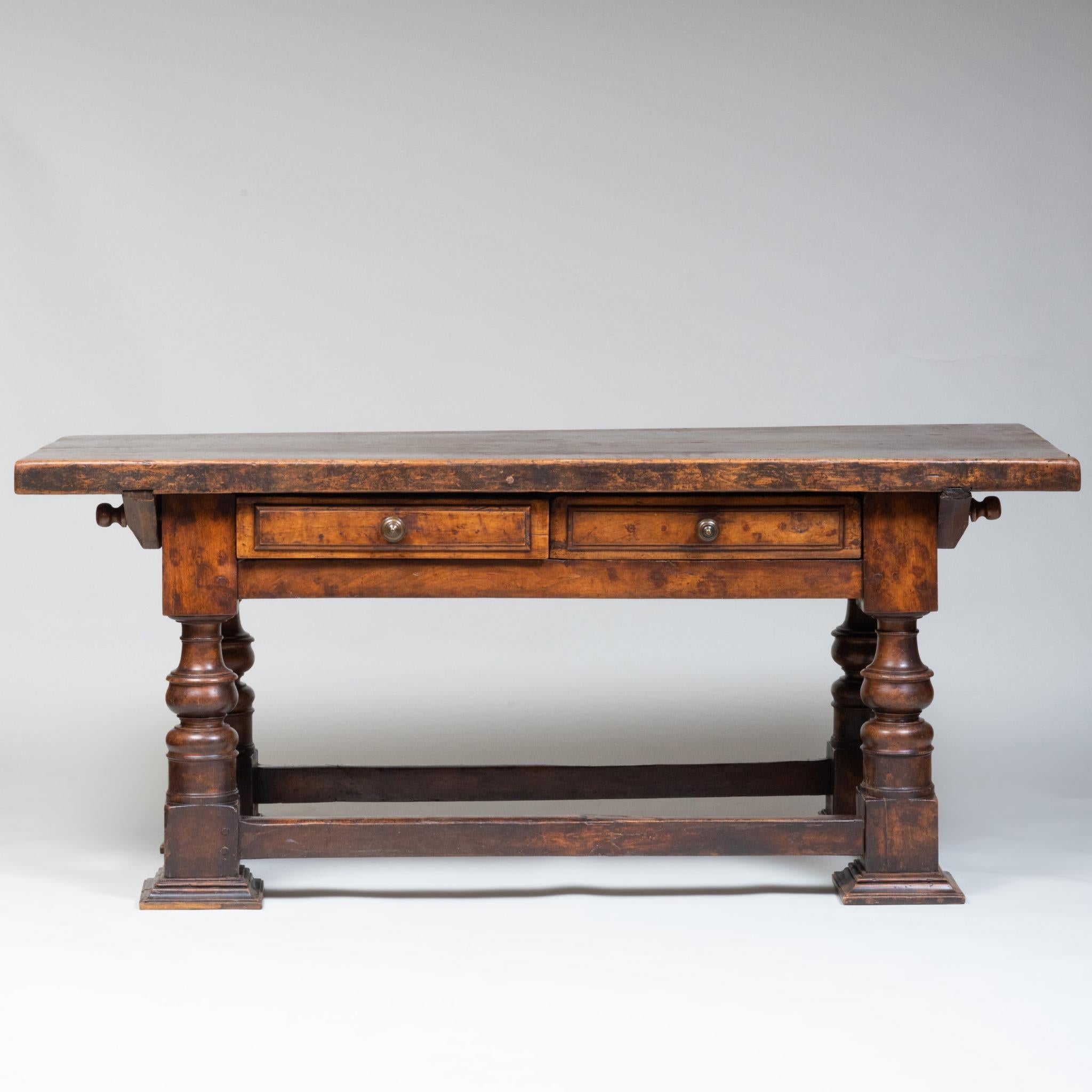 Fitted with two drawers, raised on turned legs, joinedby a stretcher on later molded flat feet.