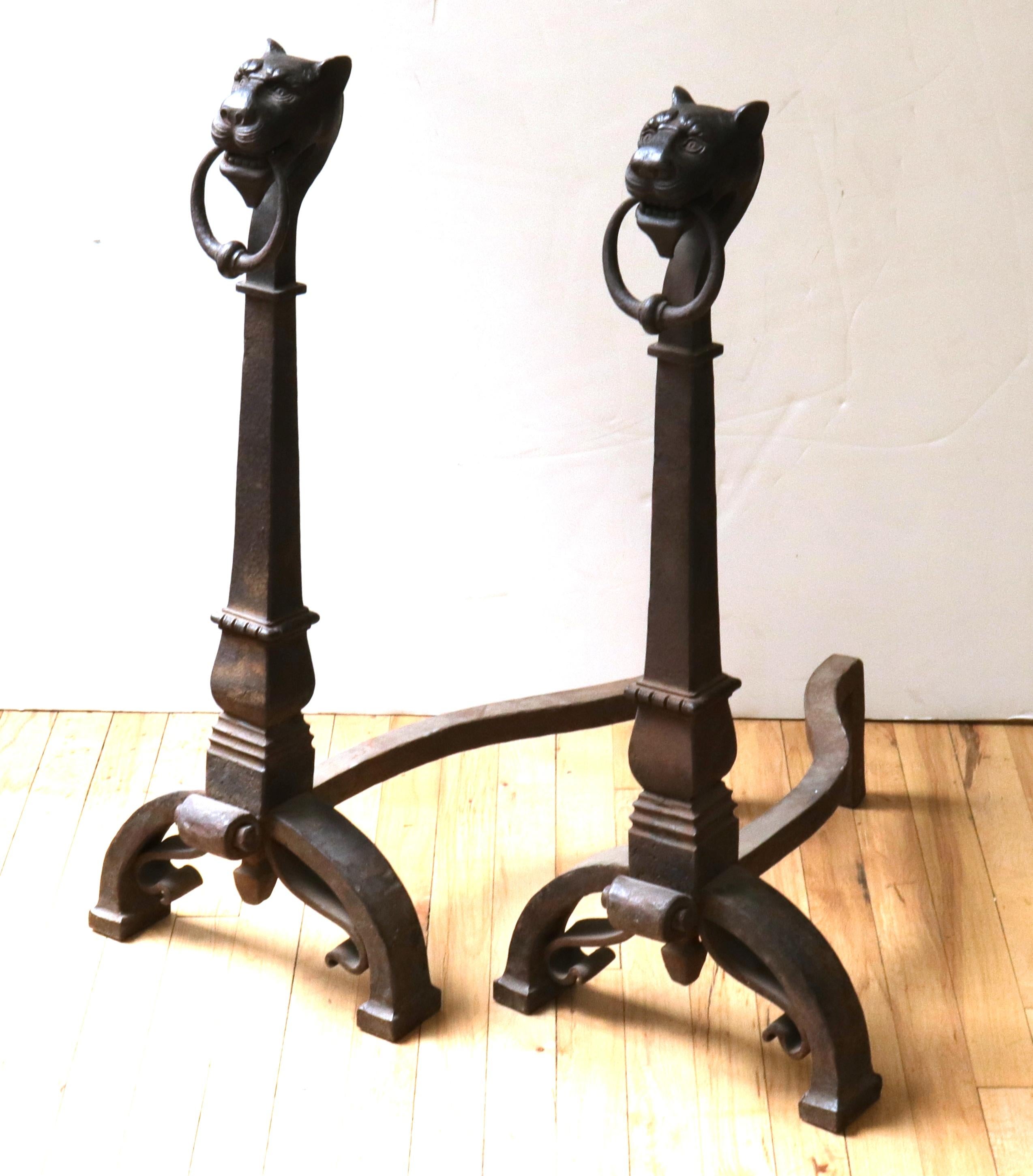 Continental 18th century pair of wrought iron andirons with finely detailed lion heads. The pair was made in Europe during the 18th century and is in great antique condition with age-appropriate wear and use and a desirable natural patina.