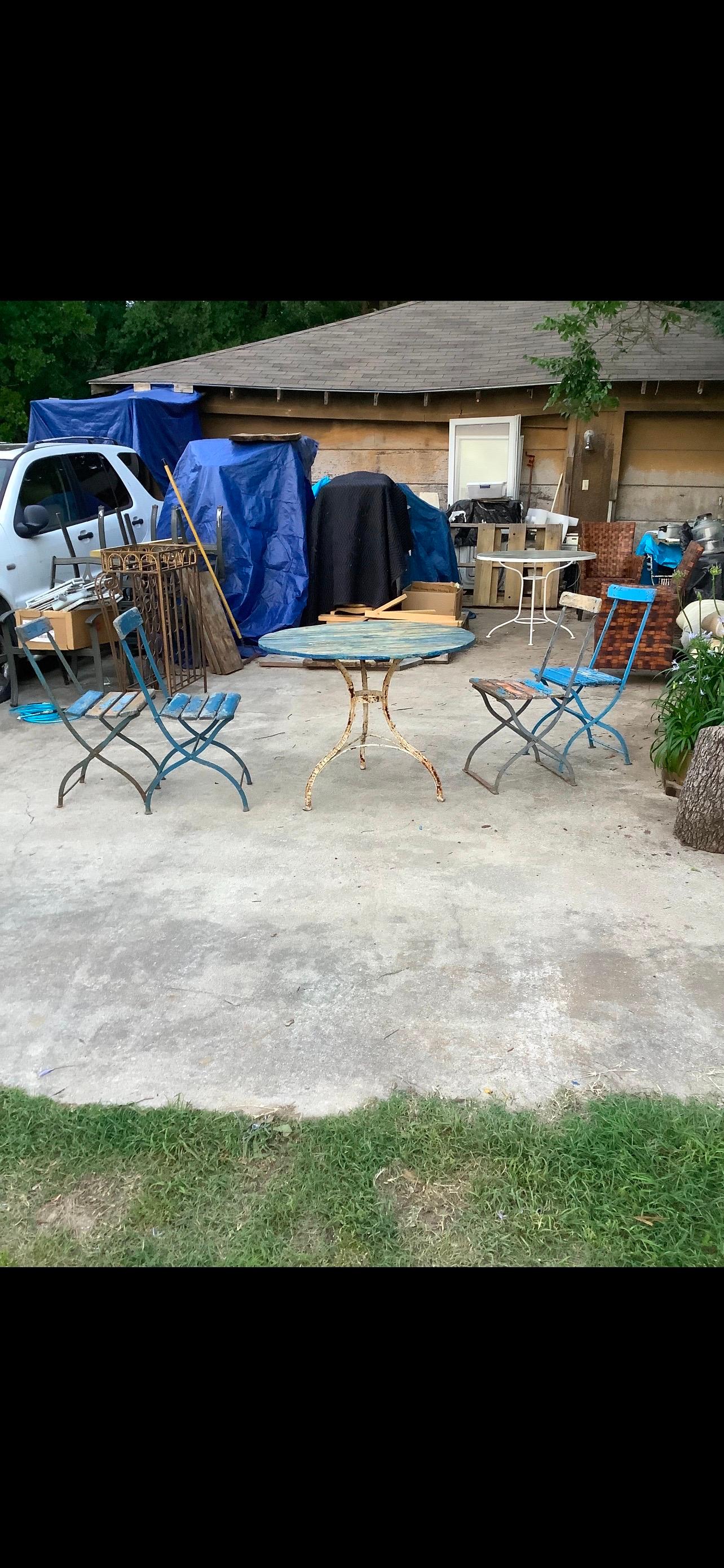 Continental Bistro Table And Chairs.
This lovely bistro or patio set is comprised of an iron table with a painted wood top with a hole for an umbrella., 4 chairs with iron bases and slatted seats and back.
All pieces have a beautifully chippy