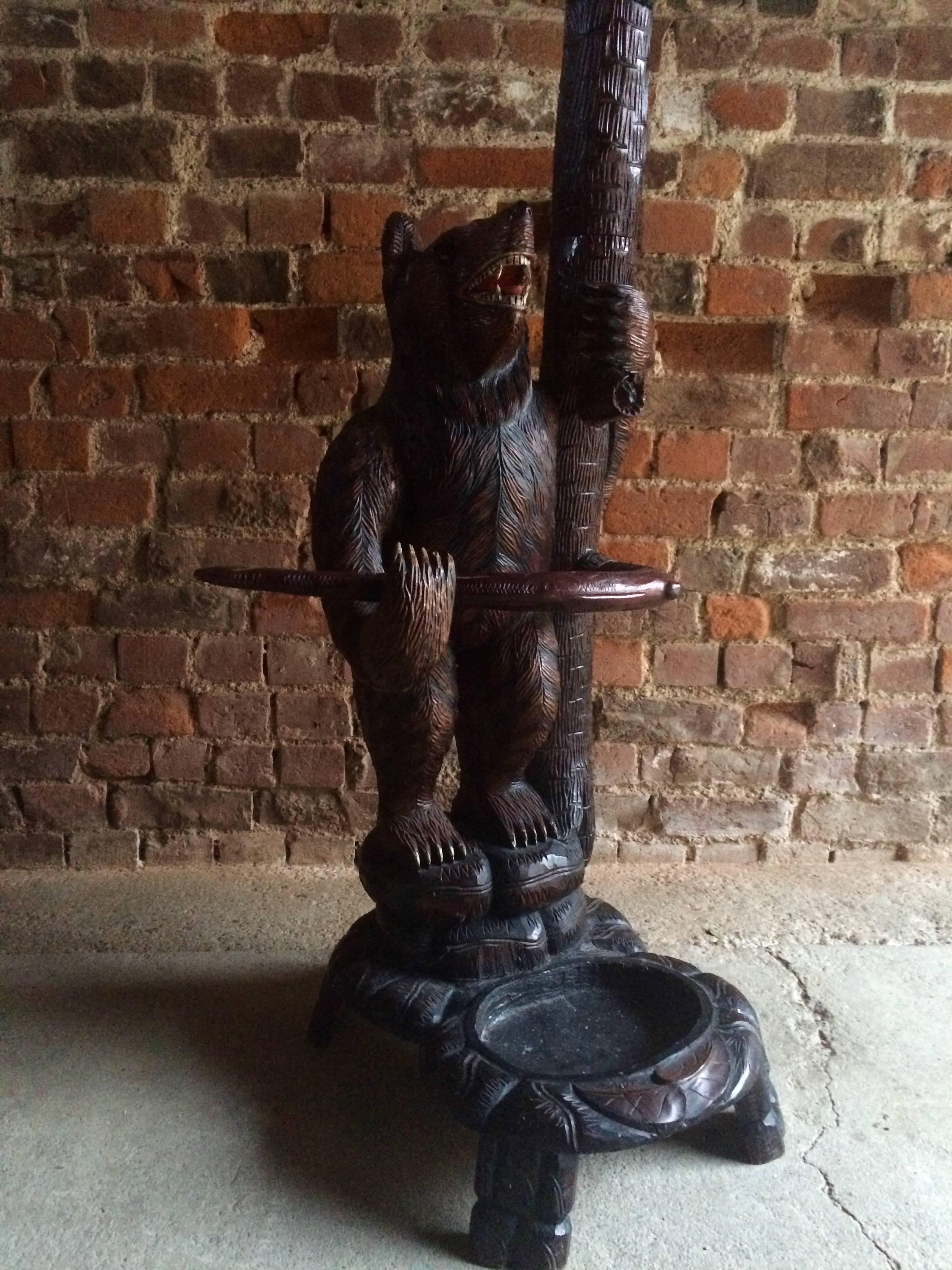 A good quality and very impressive continental Black Forest carved wood hallstand or coat stand featuring a large bear at the base of a tree, and two bear cubs in the branches, extremely ornate carvings allover.