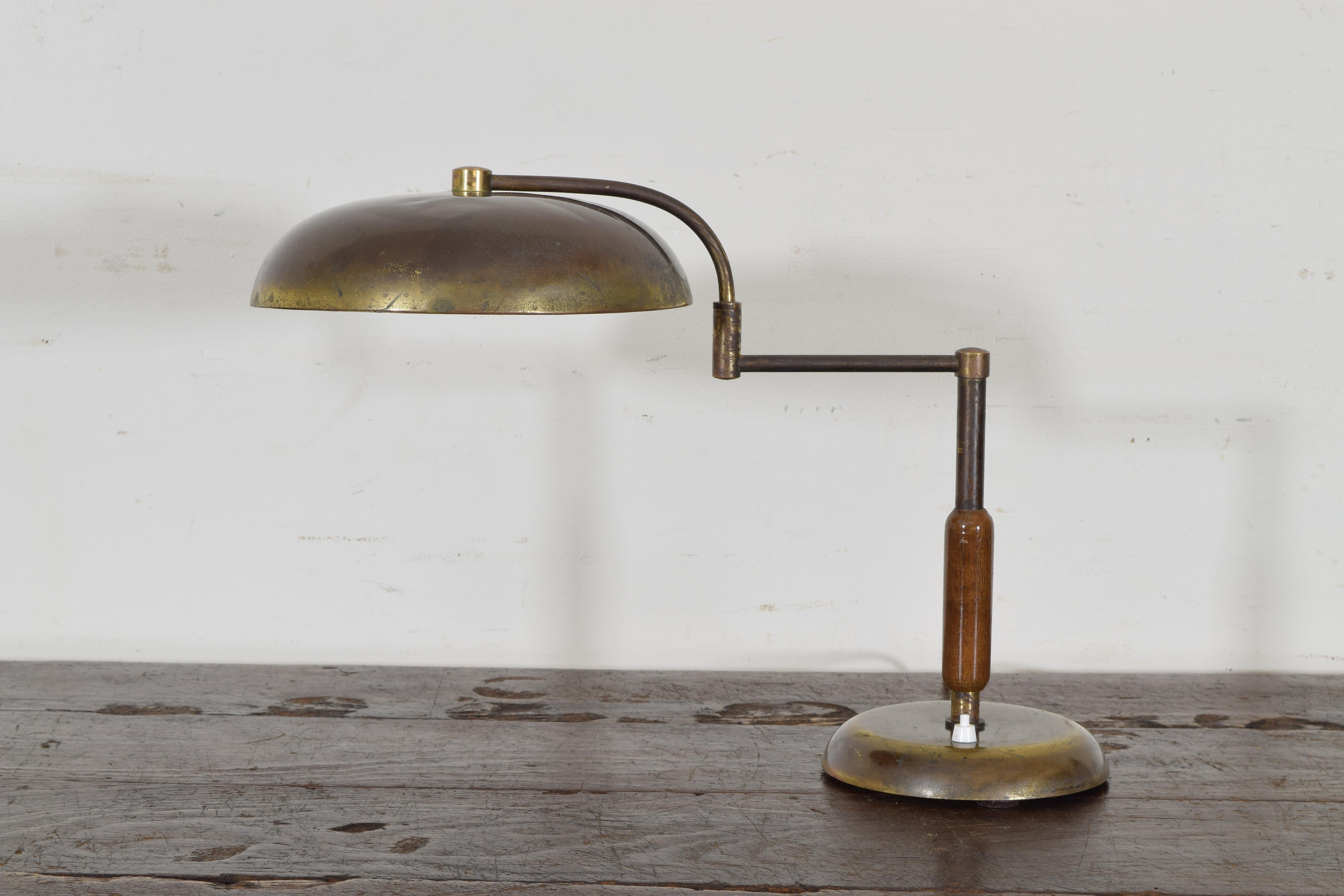 Now electrified for US, this table lamp is either French or Italian, brass with a wooden middle section, the arm adjustable.