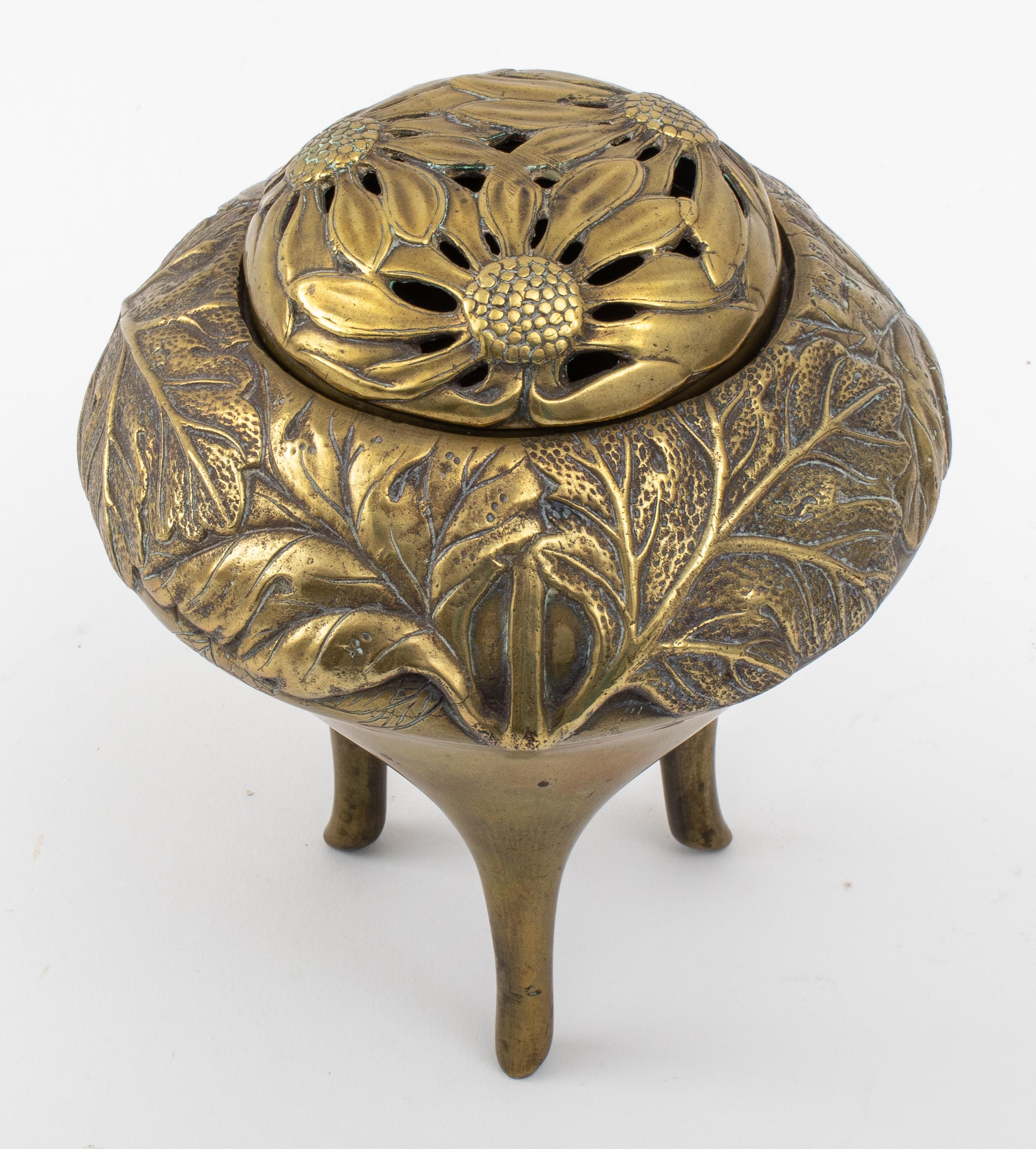 Continental Brass Art Nouveau incense burner in the Japonesque taste, the rounded chamber with pierced cover, the whole decorated with stylized floral motifs above a tripod base.

Measures: 6