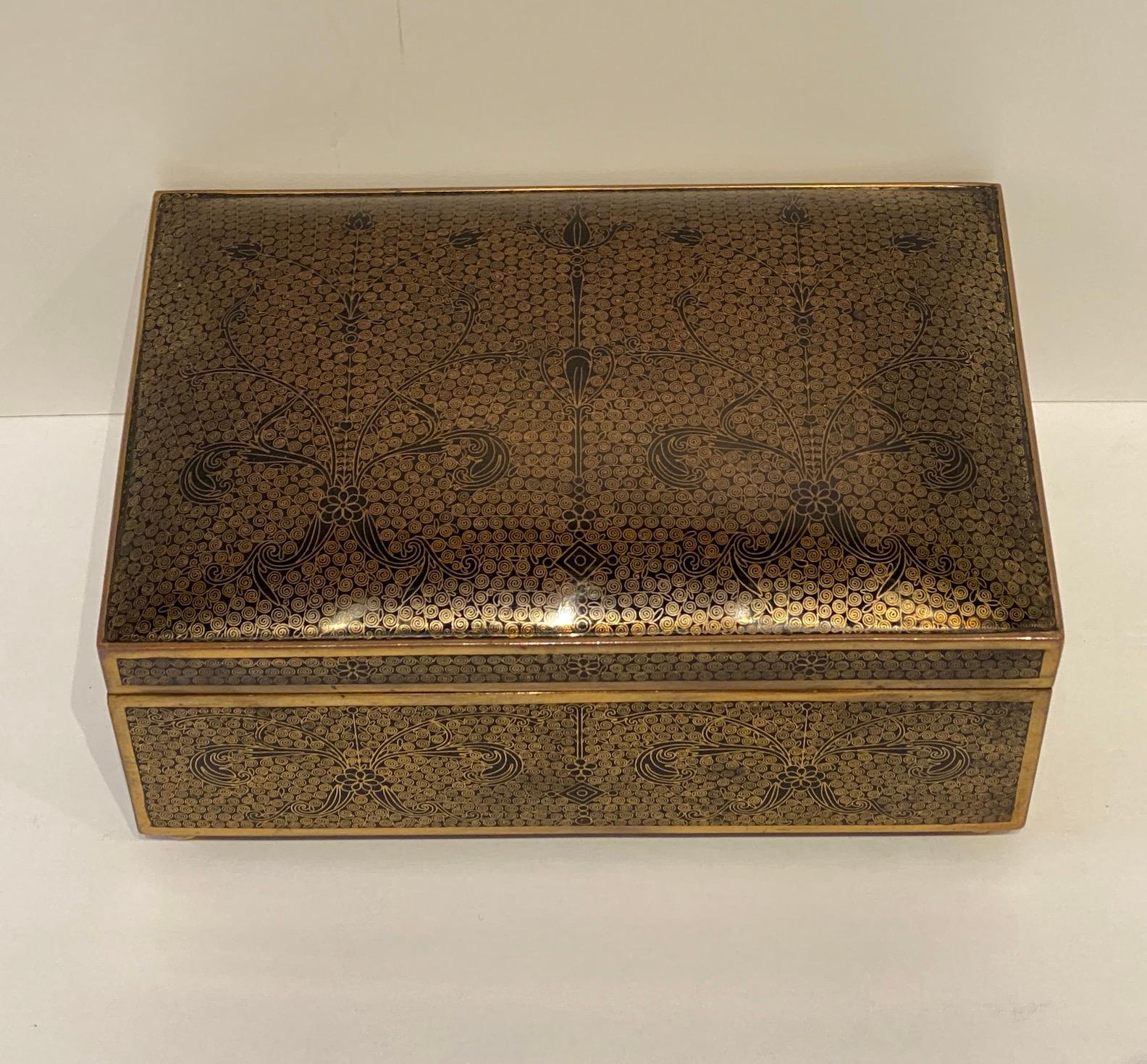 A beautiful, intricate, cloisonné hinged box with ebonzed wood liner.