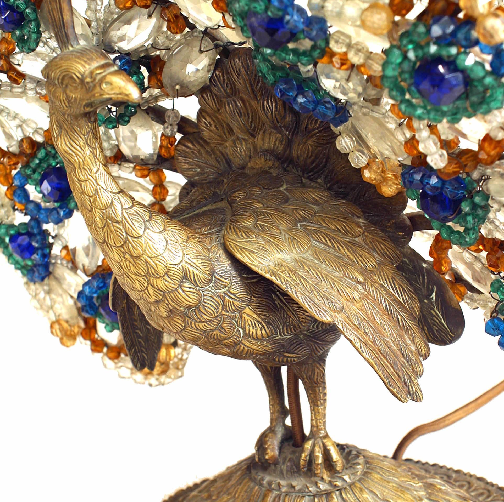 Continental first quarter of the 20th century bronze peacock base table lamp with colored glass plume and black switch (signed Made in Czechoslovakia).
  