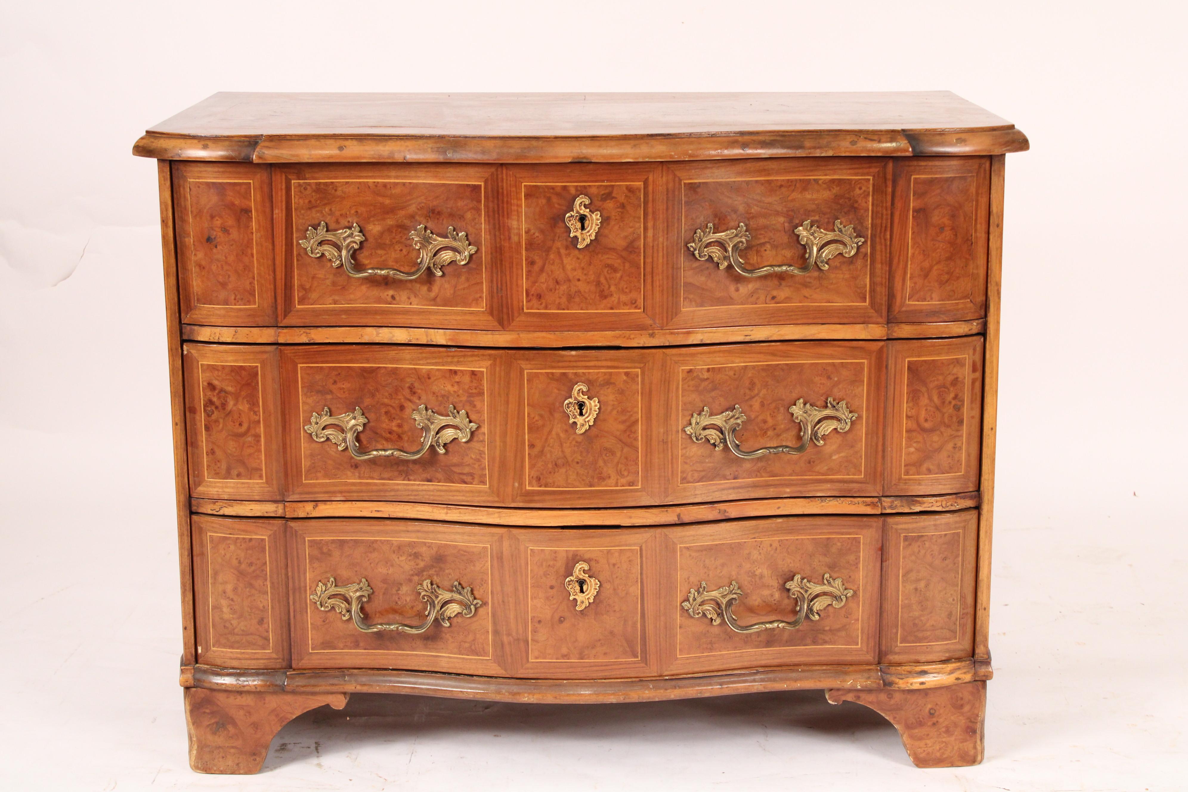 Continental burl elm 3 drawer chest of drawers, 19th century. With a serpentine shaped over hanging top with 3 serpentine shaped drawers with brass pulls and escutcheons, resting on bracket feet. 