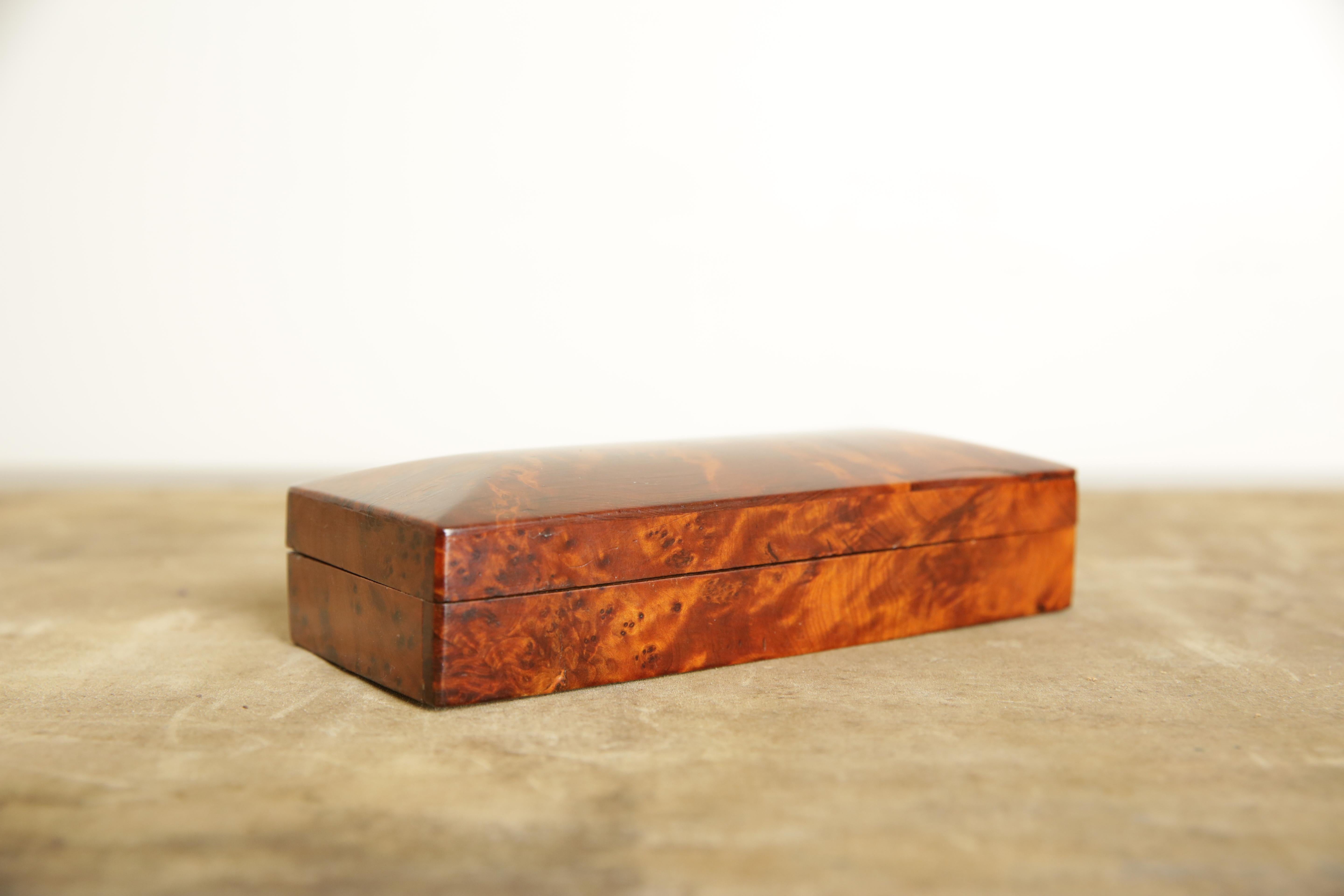 Constructed entirely of camphor wood and having a slightly domed top on a conforming case, hinges at rear