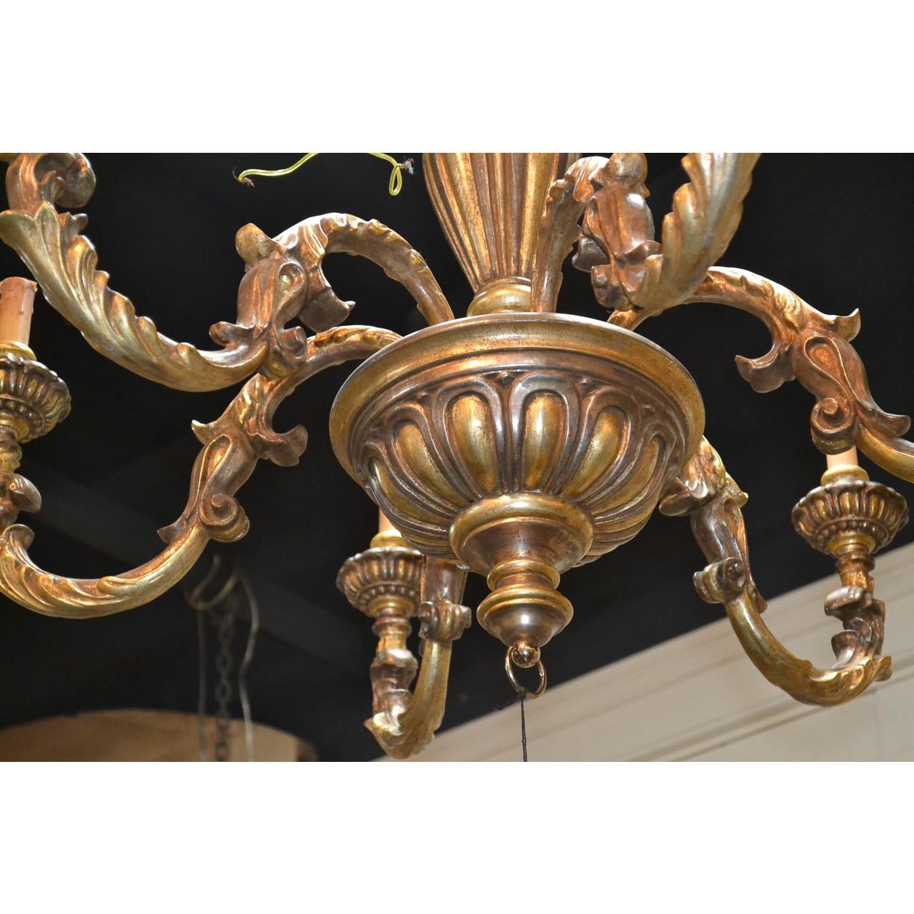 Excellent quality midcentury Continental carved two-tone gold-gilded chandelier with a finely carved and tapered stem atop a bowl-shaped mid-section with six acanthus motif scrolled arms having delicately scalloped candle cups,

circa 1940.