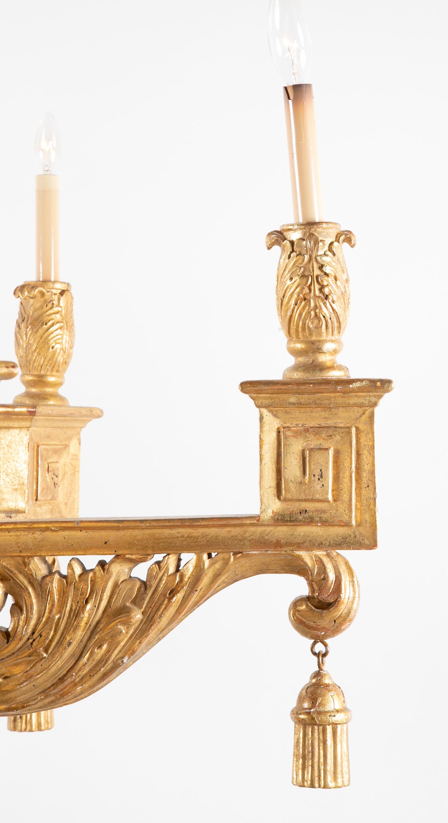 Continental carved and gilded six-arm classical chandelier with drop finial.