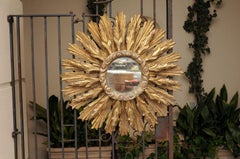 Continental Carved Giltwood Sunburst Mirror with Layered Rays and Cloudy Motifs
