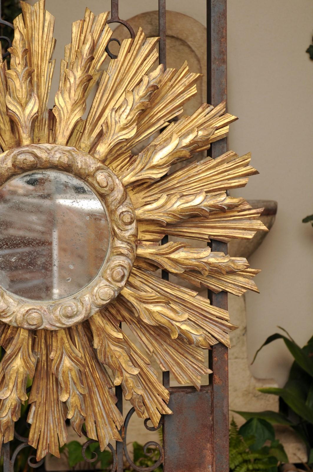 Continental Carved Giltwood Sunburst Mirror with Layered Rays and Cloudy Motifs In Good Condition In Atlanta, GA