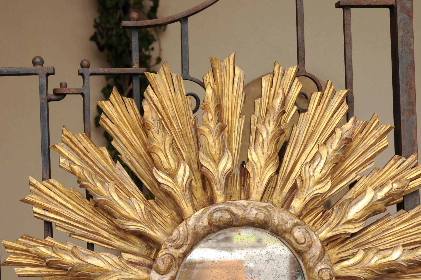 Continental Carved Giltwood Sunburst Mirror with Layered Rays and Cloudy Motifs 1