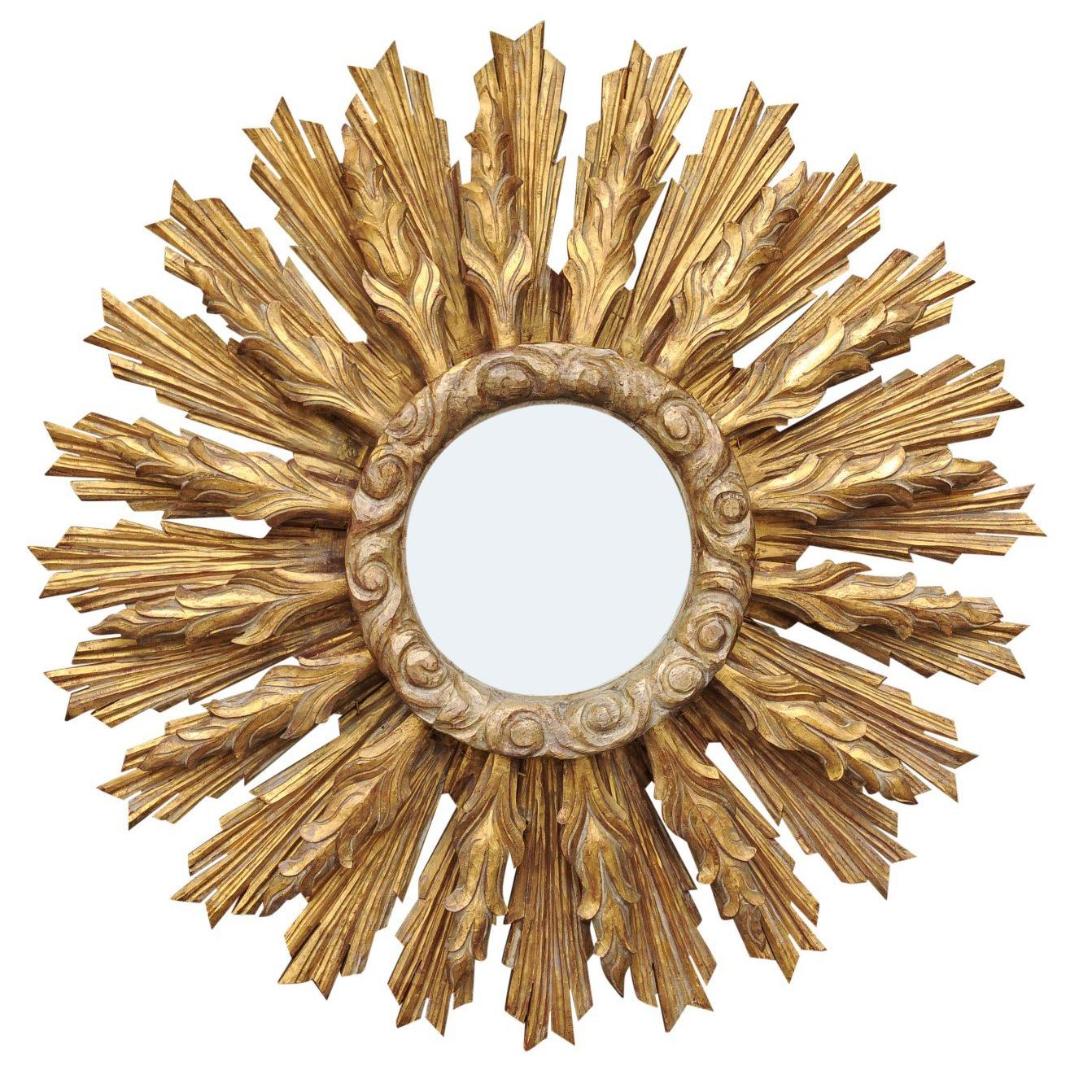 Continental Carved Giltwood Sunburst Mirror with Layered Rays and Cloudy Motifs