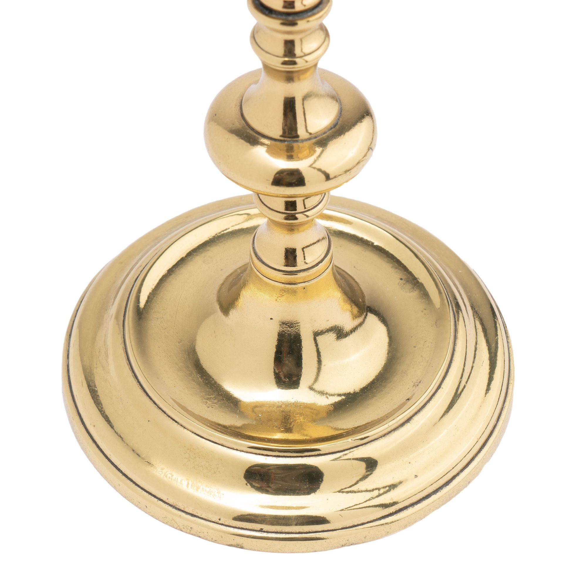 European Continental cast brass circular base candlestick, 1720-40 For Sale