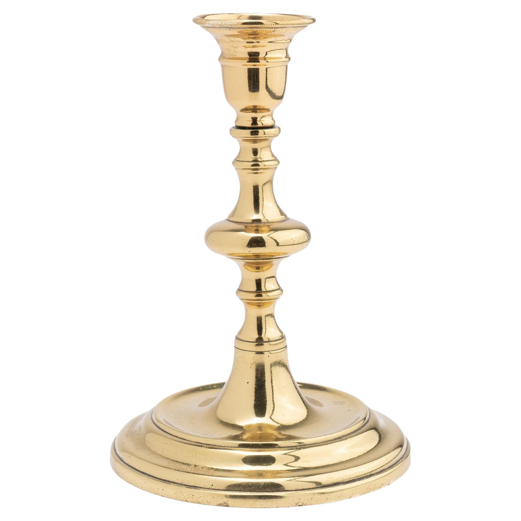 Continental cast brass circular base candlestick, 1720-40 For Sale