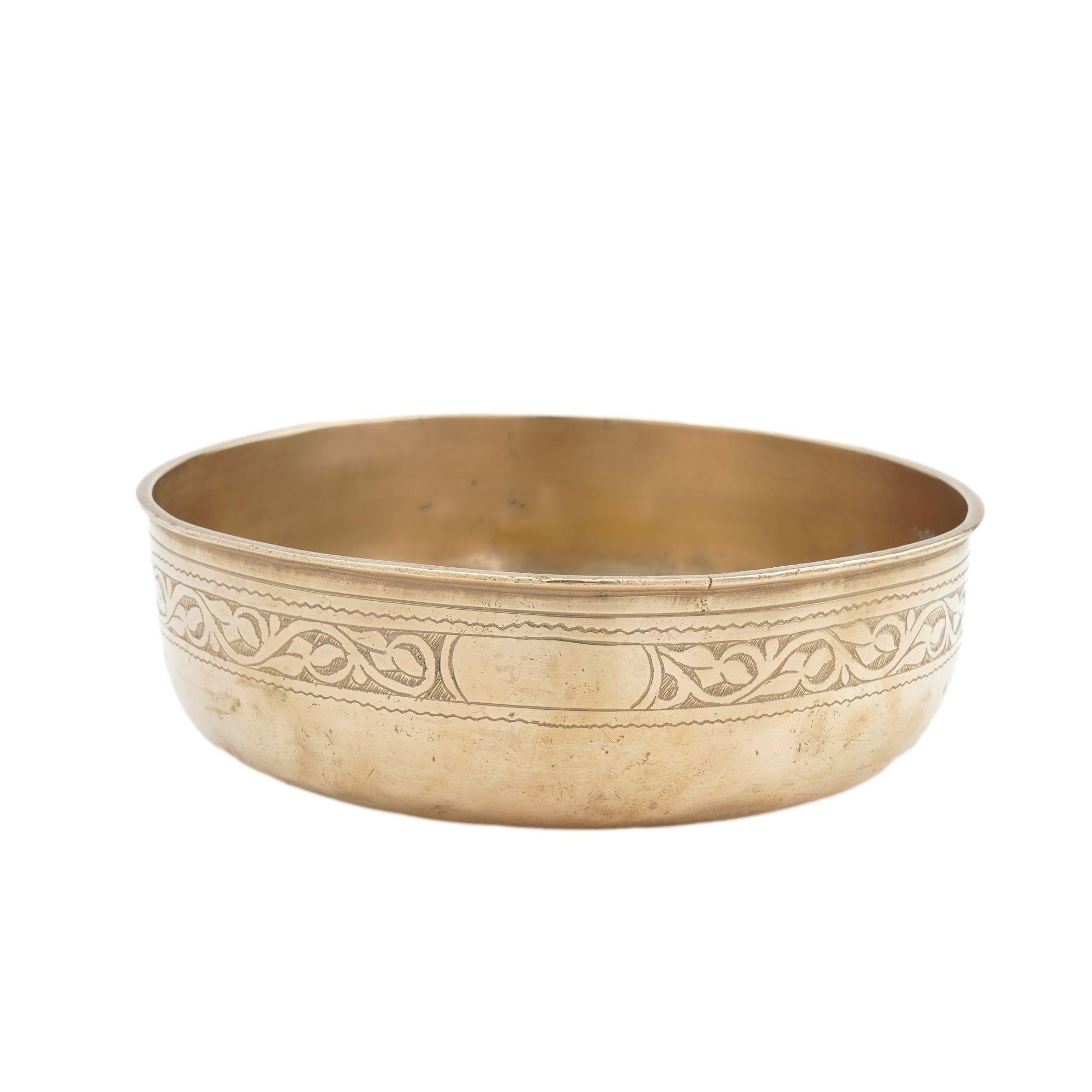 Cast and lathe turned bronze basin. The vertical sides have a beaded rim over an engraved floral band, and the single piece casting has a radius form base.

Continental, 19th century.