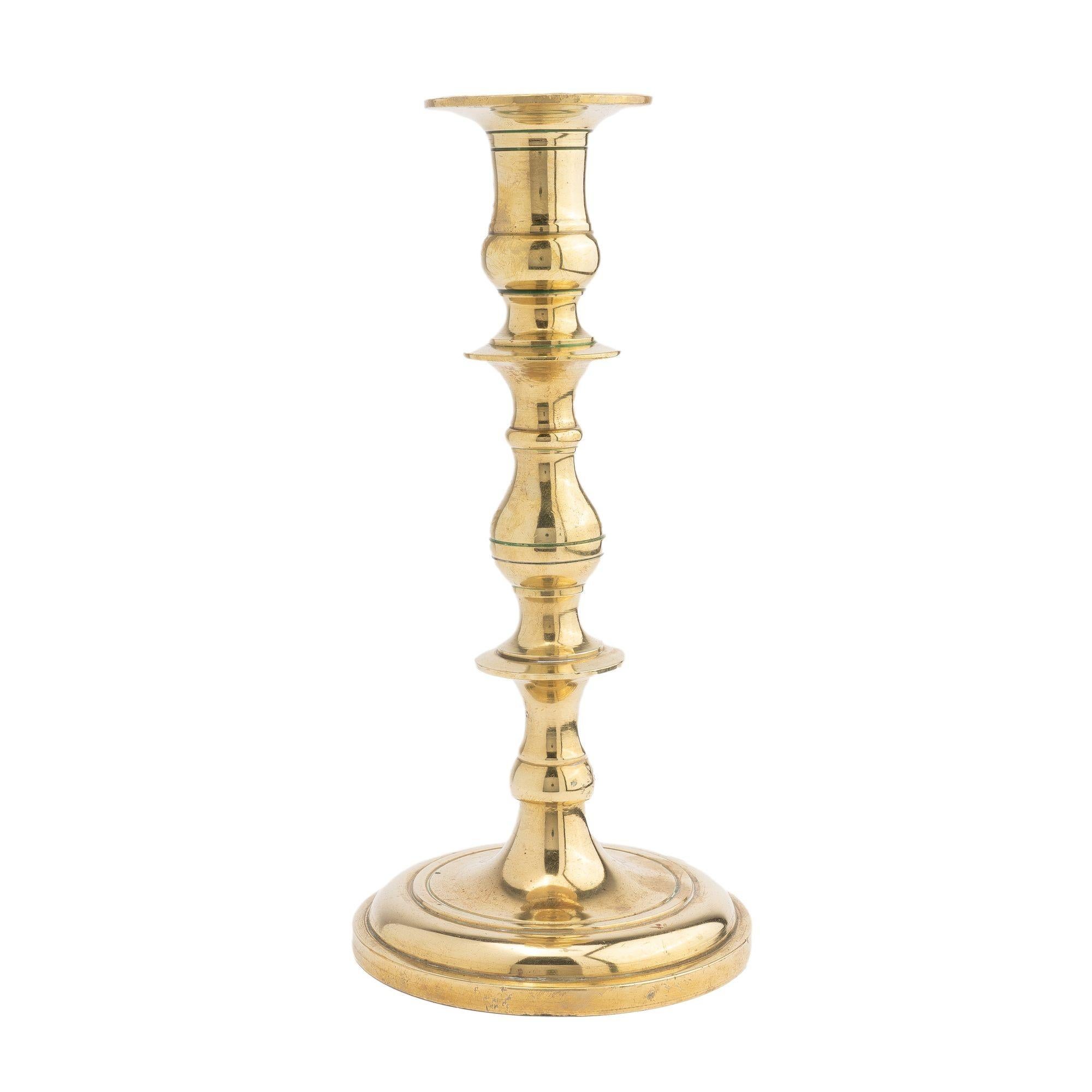 Core cast brass candlestick with a reel and knob shaft screwed to a circular domed base
Continental, 1700's.