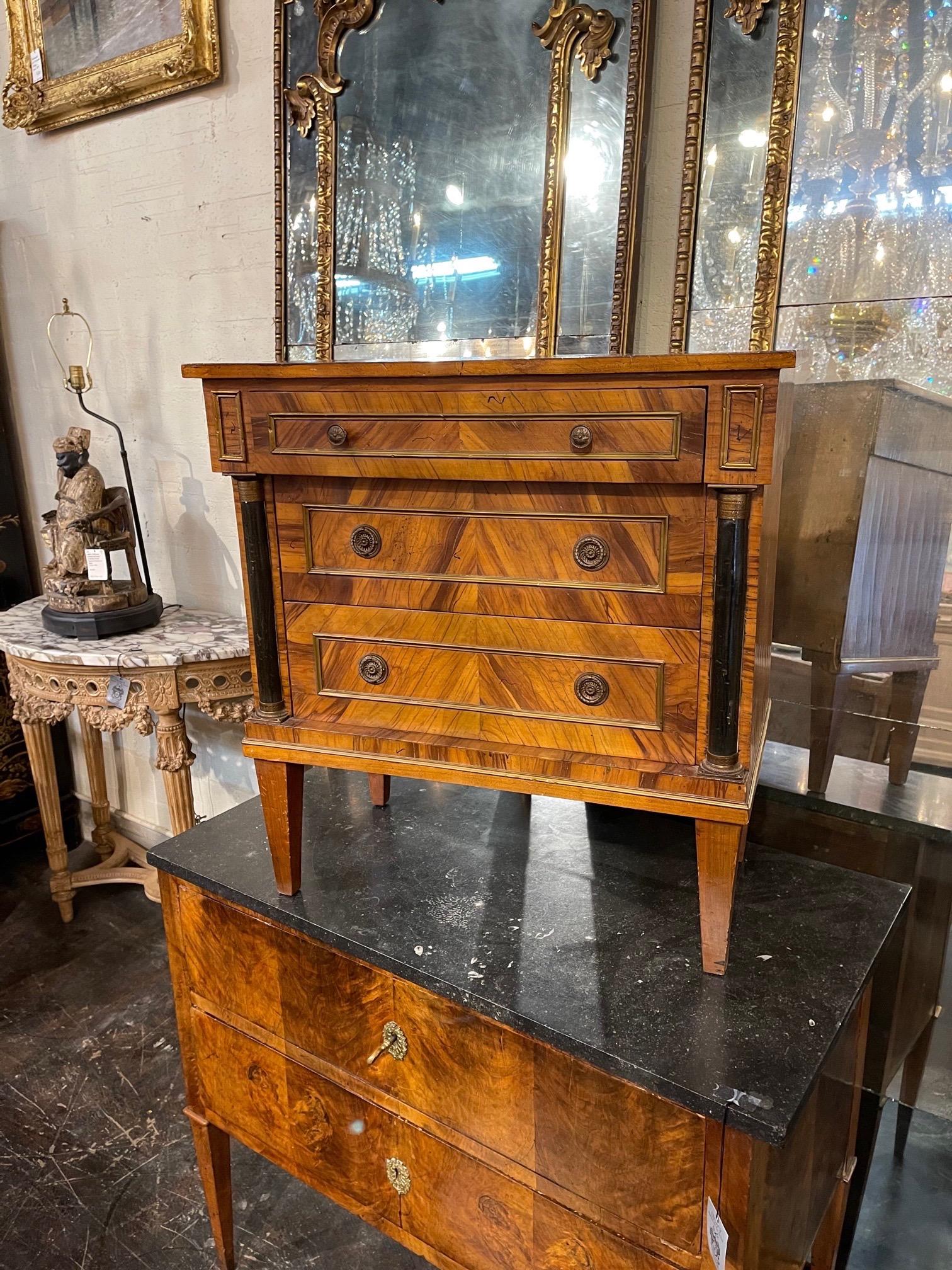 Handsome early 20th century Continental Empire style burl wood side table. Very fine finish on this piece with ebonized details and pretty hardware. An elegant piece!