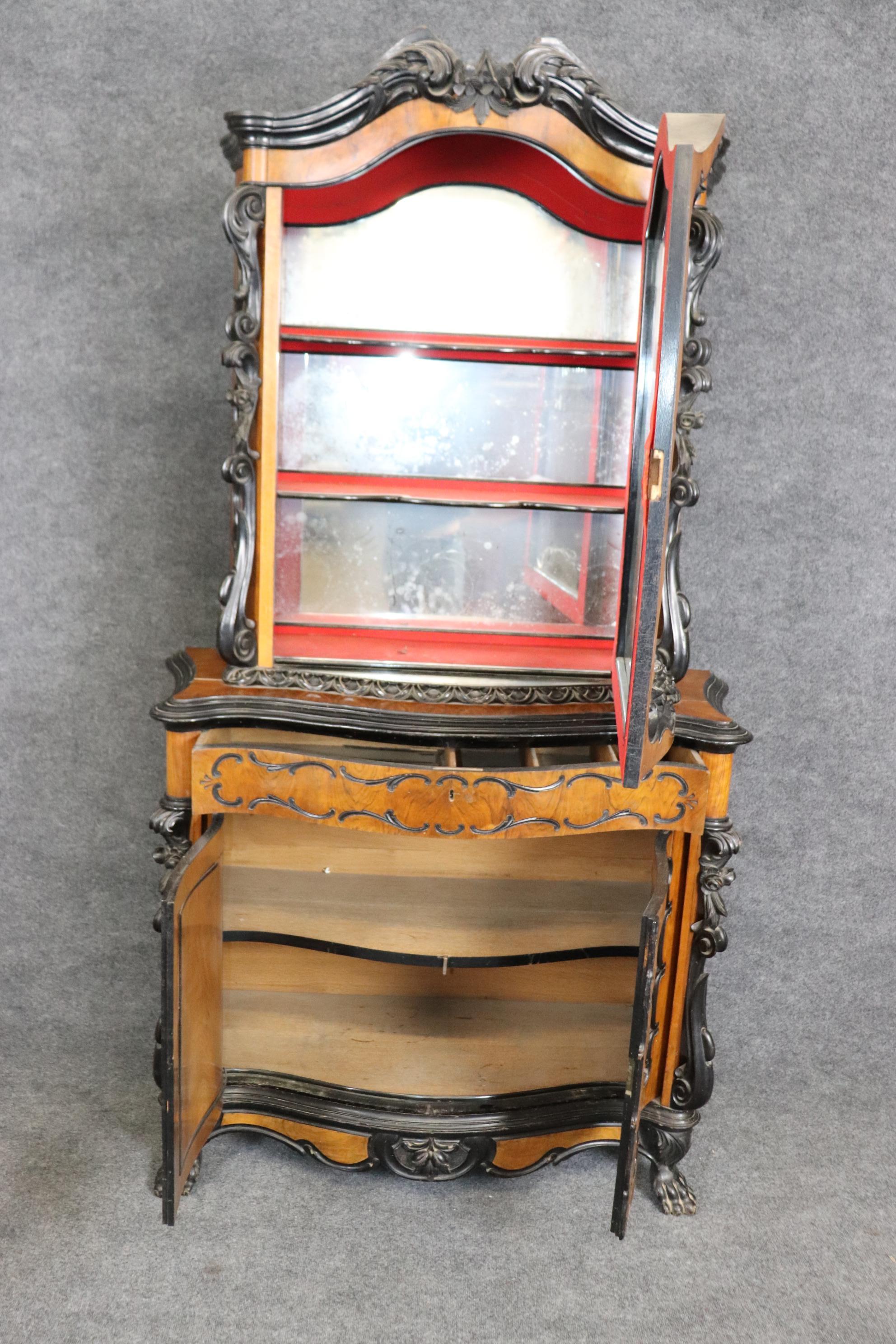 This is a gorgeous cabinet with red velvet interior for the shelving. The cabinet features extraoridinary wood quality with ebonized accents and no major damages, wear or issues beyond time-worn issues. Measures 85 tall x 46.25 x 19 inches deep.
