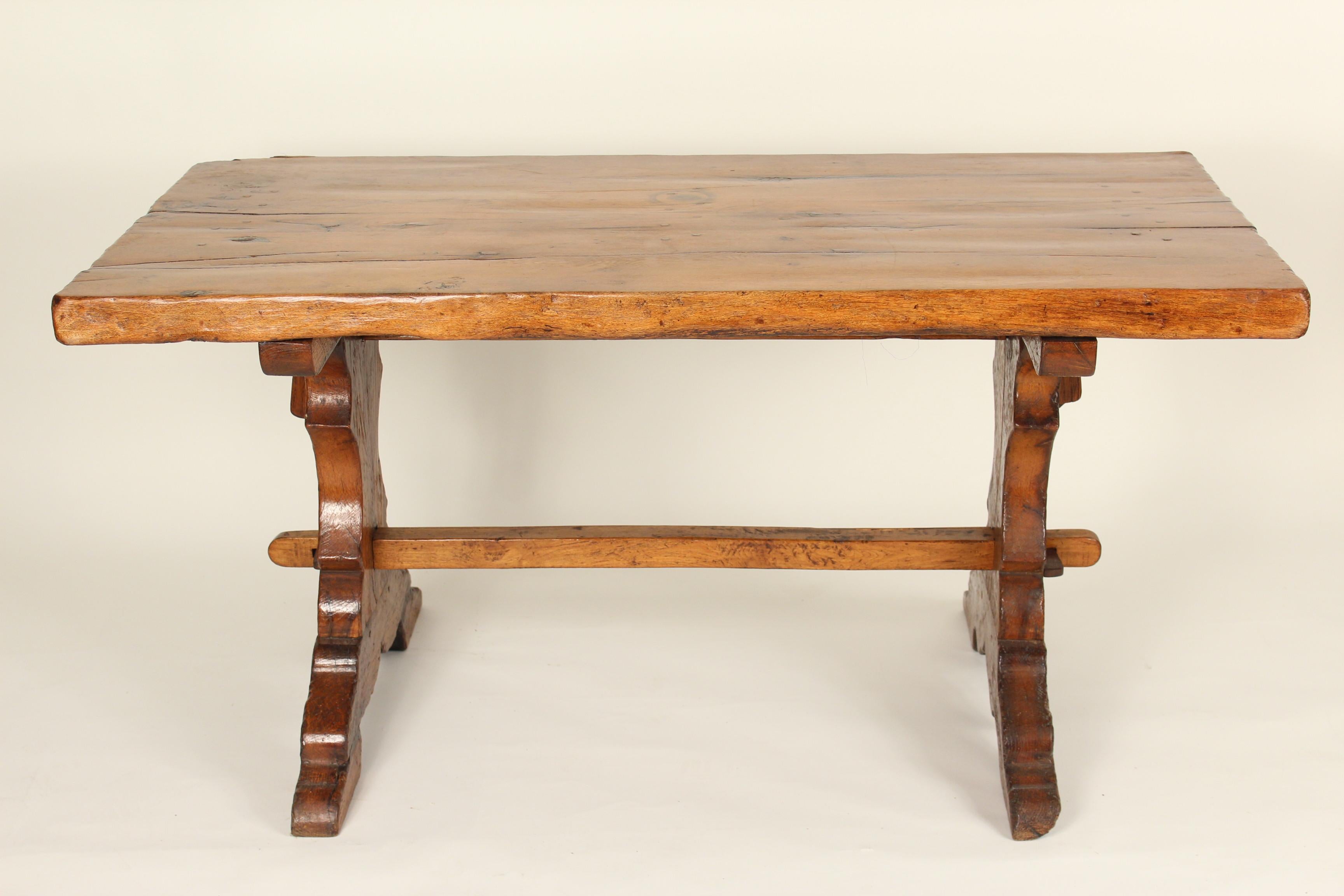 Baroque style continental fruitwood trestle style dining room table, 19th century. This table could also be used as a writing table. Mortise and tenon construction and nice old color.
