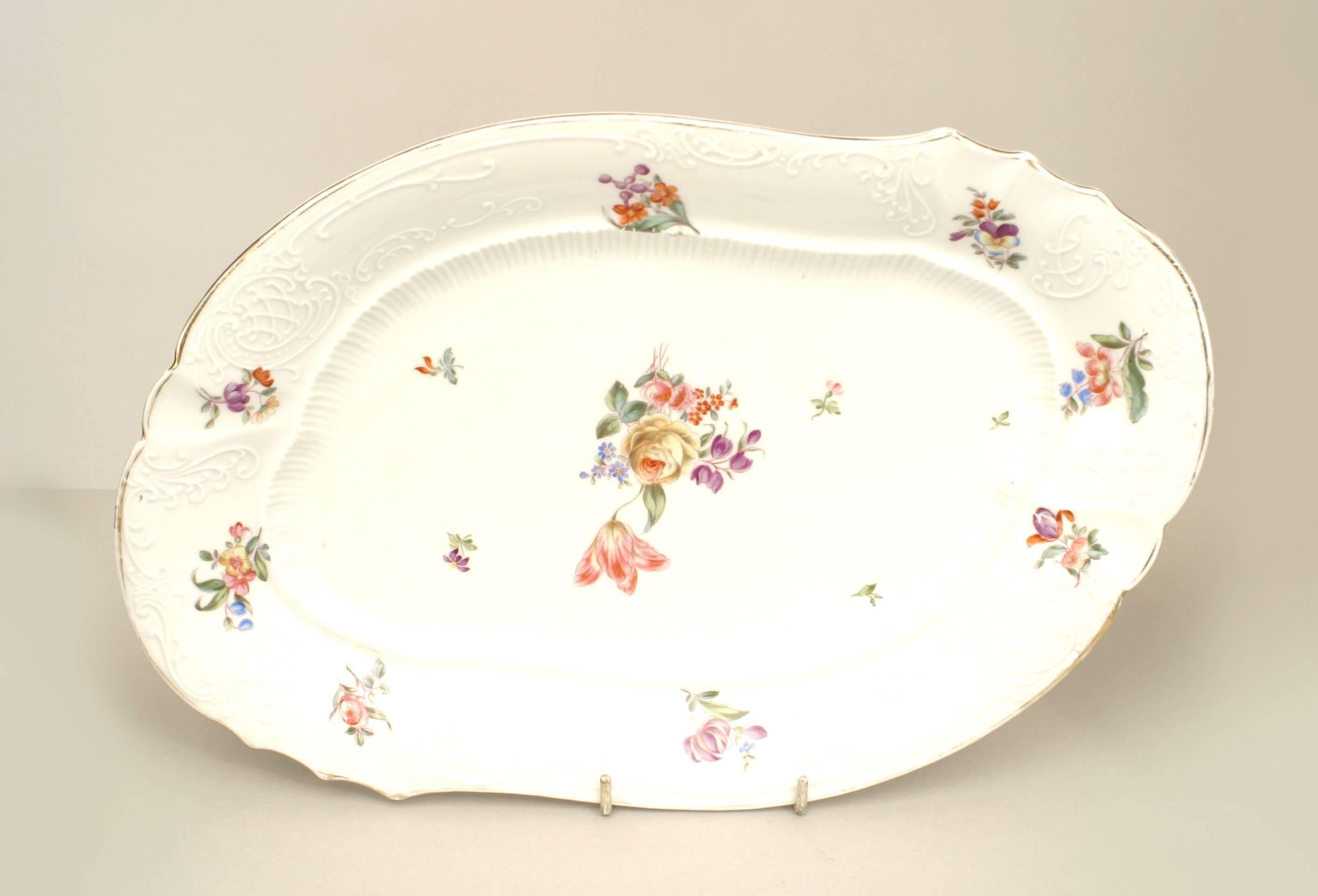 Continental German (19th Century) white porcelain dinner service painted with floral decoration & scalloped edge with gilt trim - 102 pieces total. (PRICED AS SET)
