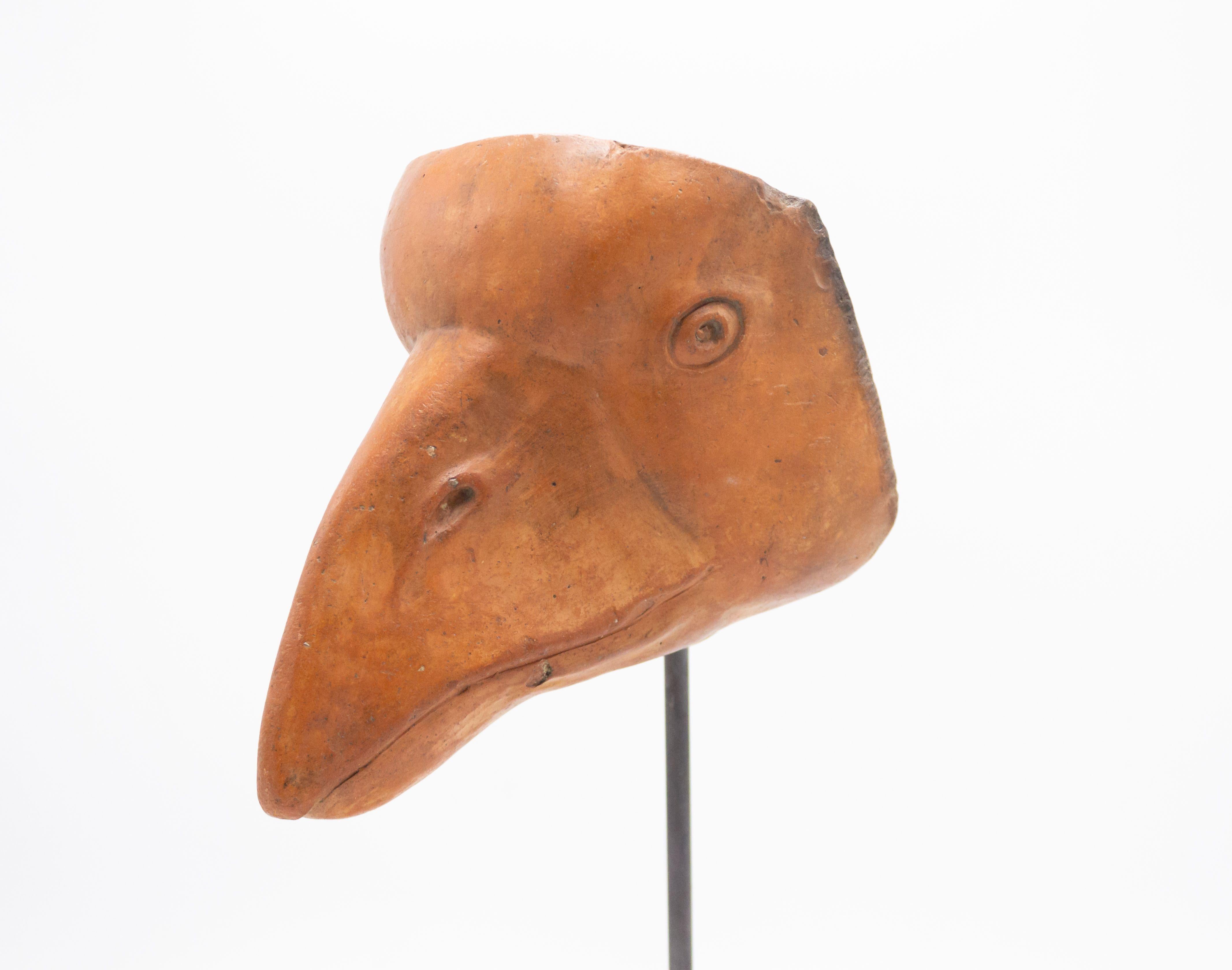 Continental German (late 19th cent) sculpted terra-cotta master mask mold of a goose face with a large bill displayed on a square black marble base stand (part of a 39 piece collection).
    