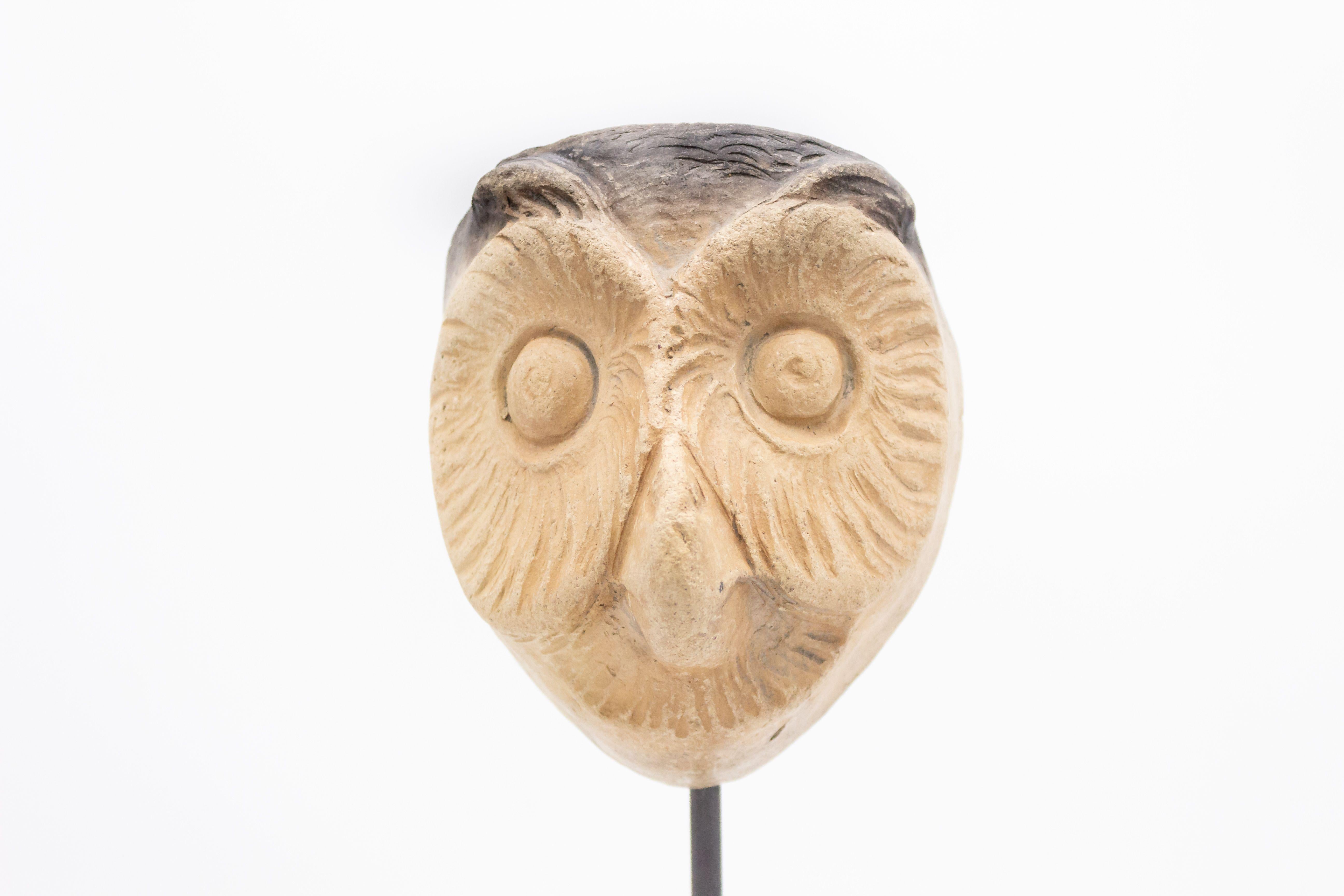 Continental German (late 19th Cent) sculpted terra-cotta master mask mold of a medium sized owl face displayed on a square black marble base stand (part of a 39 piece collection).
 