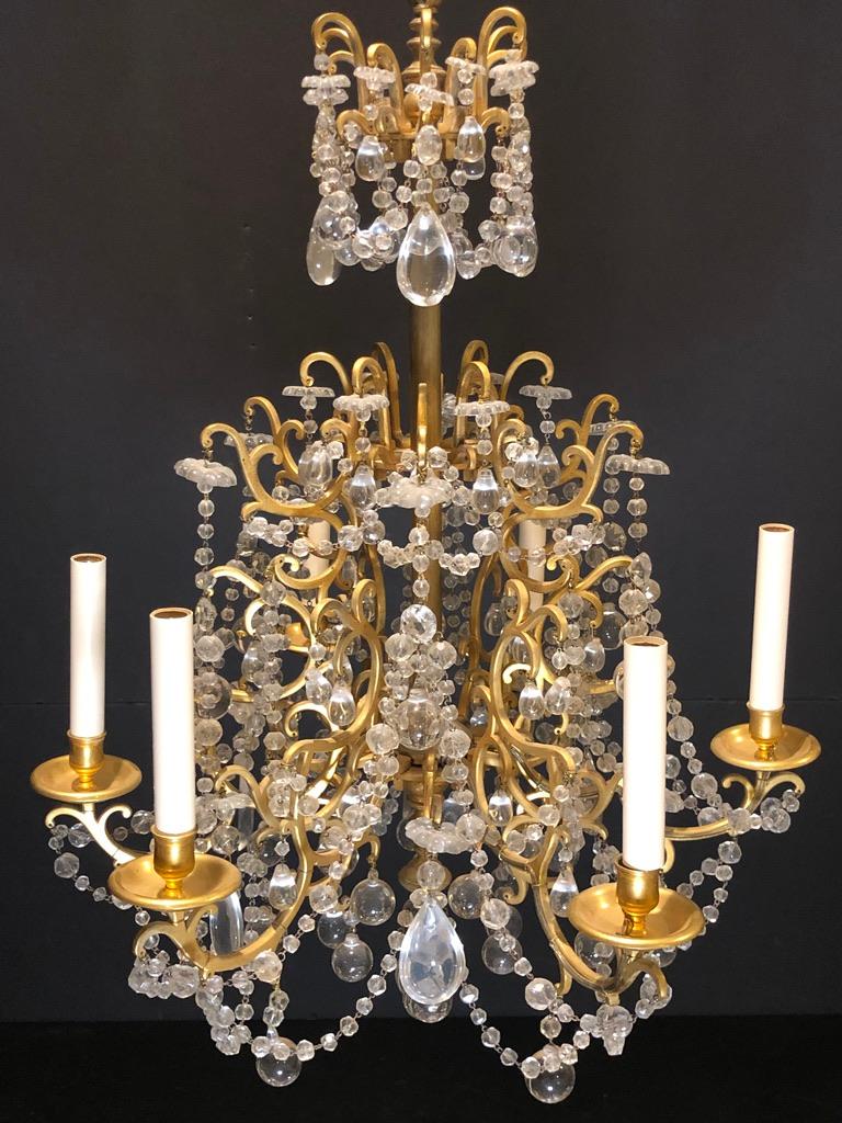  Original 19th century French candlelight gilt bronze and crystal chandelier. Simple and elegant original candle light chandelier having scrolled arms that are fitted into a center body as square pegs. Six-arms/lights wired with tied outside wiring.