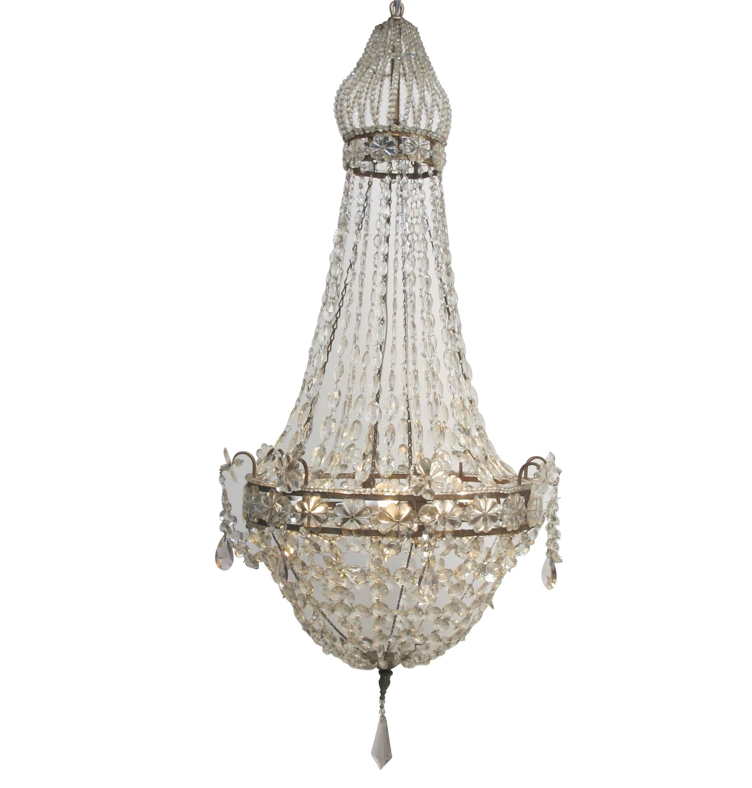 Unique gilt iron and large faceted crystal chandelier with beaded bell shape cage at the top continuing down to strands of graduated and faceted square crystals to an gilt Iron frame with large glass rosettes and accented with amethyst drops.