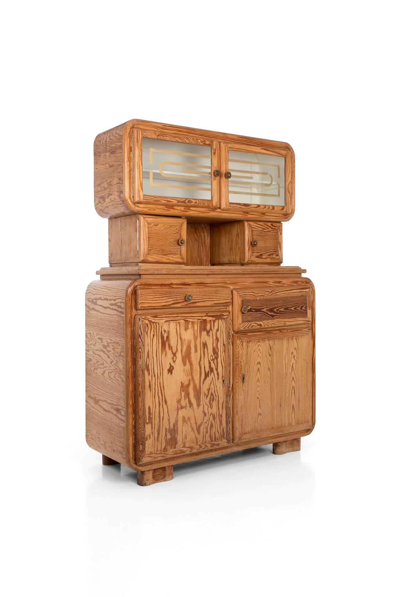 Hoosier’ pine kitchen cabinet with fabulous Art Deco appeal to its rounded corners and edges. Featuring a shallow shelved upper cabinet, a small coffee grinder cupboard and a wonderful set of six ceramic spice drawers. Wooden countertop over a