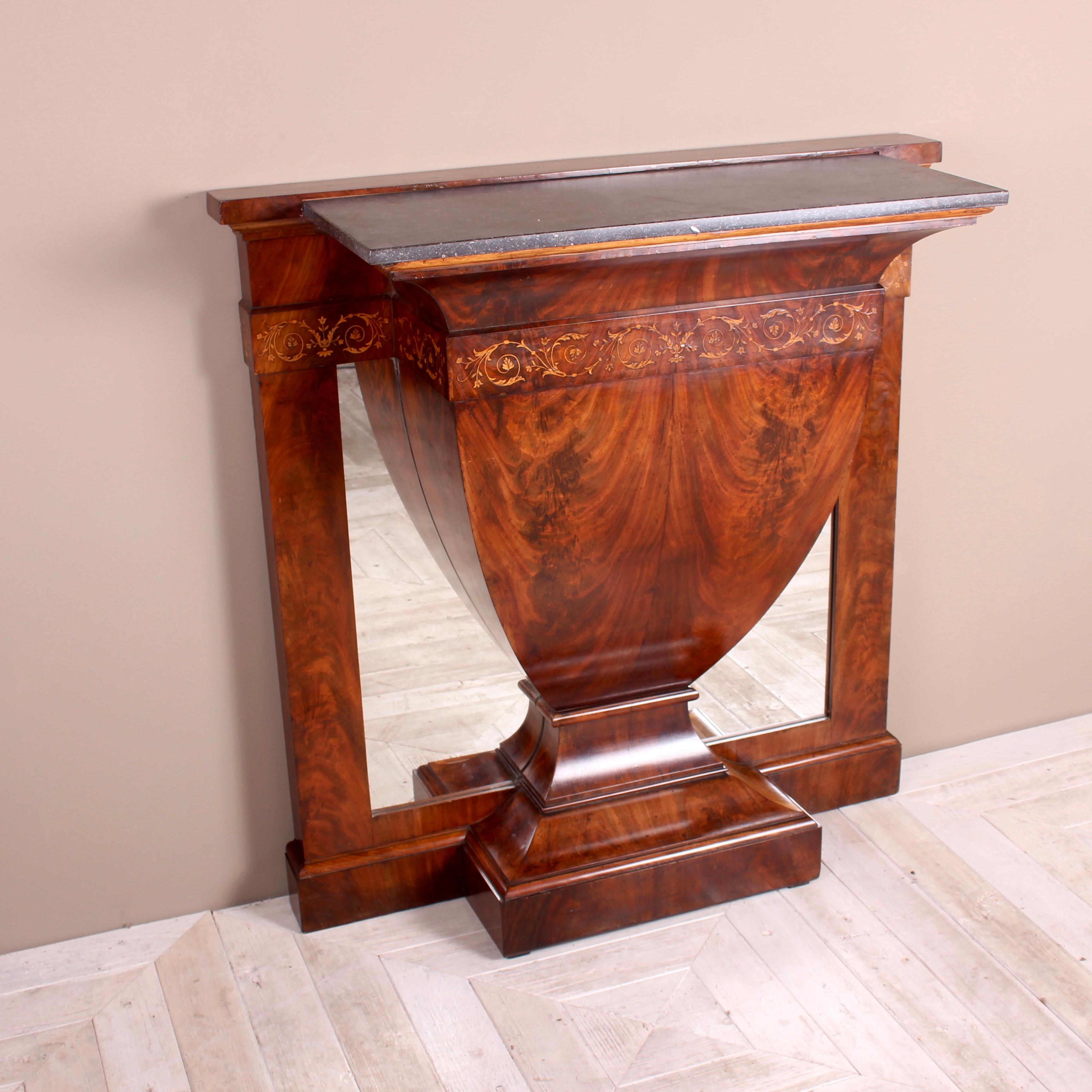 A lovely inlaid mahogany console table with grey marble its top. Having the most wonderful urn-shaped centre section. Beautifully inlaid with scrolling floral decoration to the upper frieze. The grey marble slab sits above the central urn-shaped