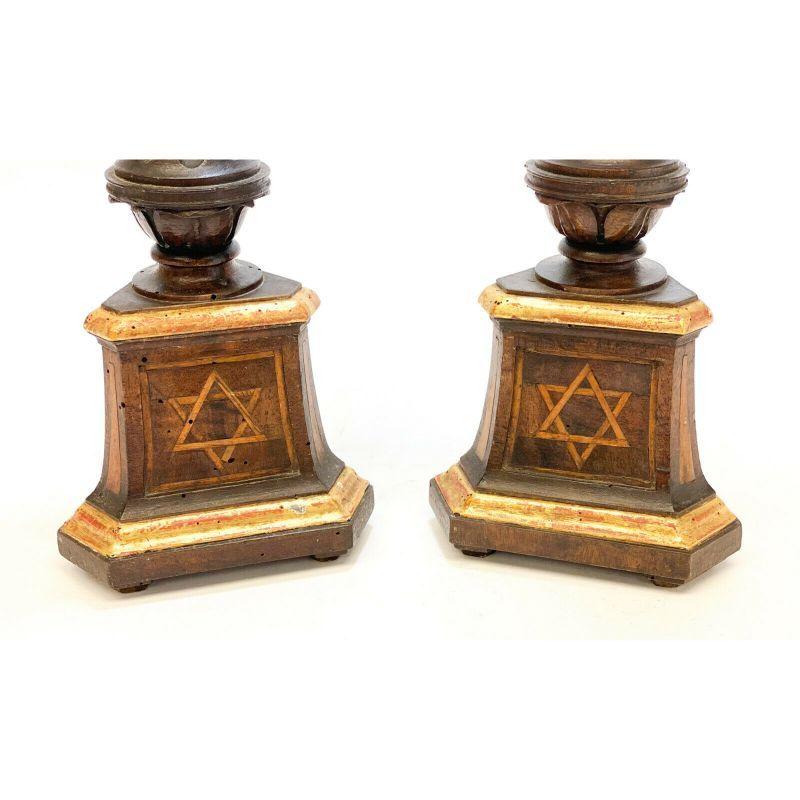 Continental Inlaid Wood Sabbath Candlesticsk Holders with Star of David Judaica

A pair of Continental Judaica wooden candlestick holder pricks, 19th century. Hand carved leaves to the columns with wood inlaid marquetry Star of David to the