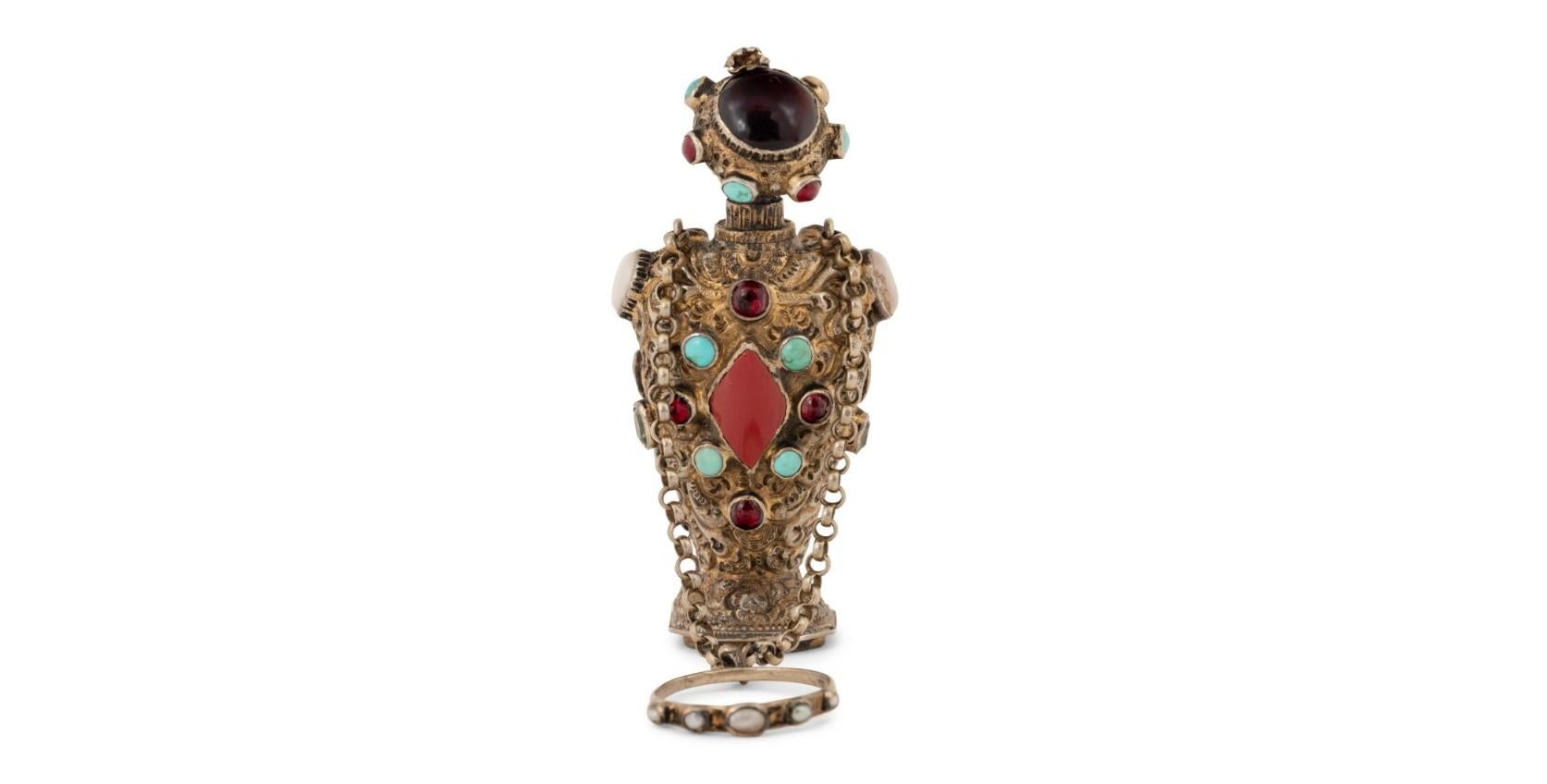 Create an air of luxury and elegance in your collection with this stunning Continental Jeweled Silver Figural Scent Bottle and Hand Seal. Crafted during the illustrious period of the 18th/19th century, this exquisite piece is sure to captivate any
