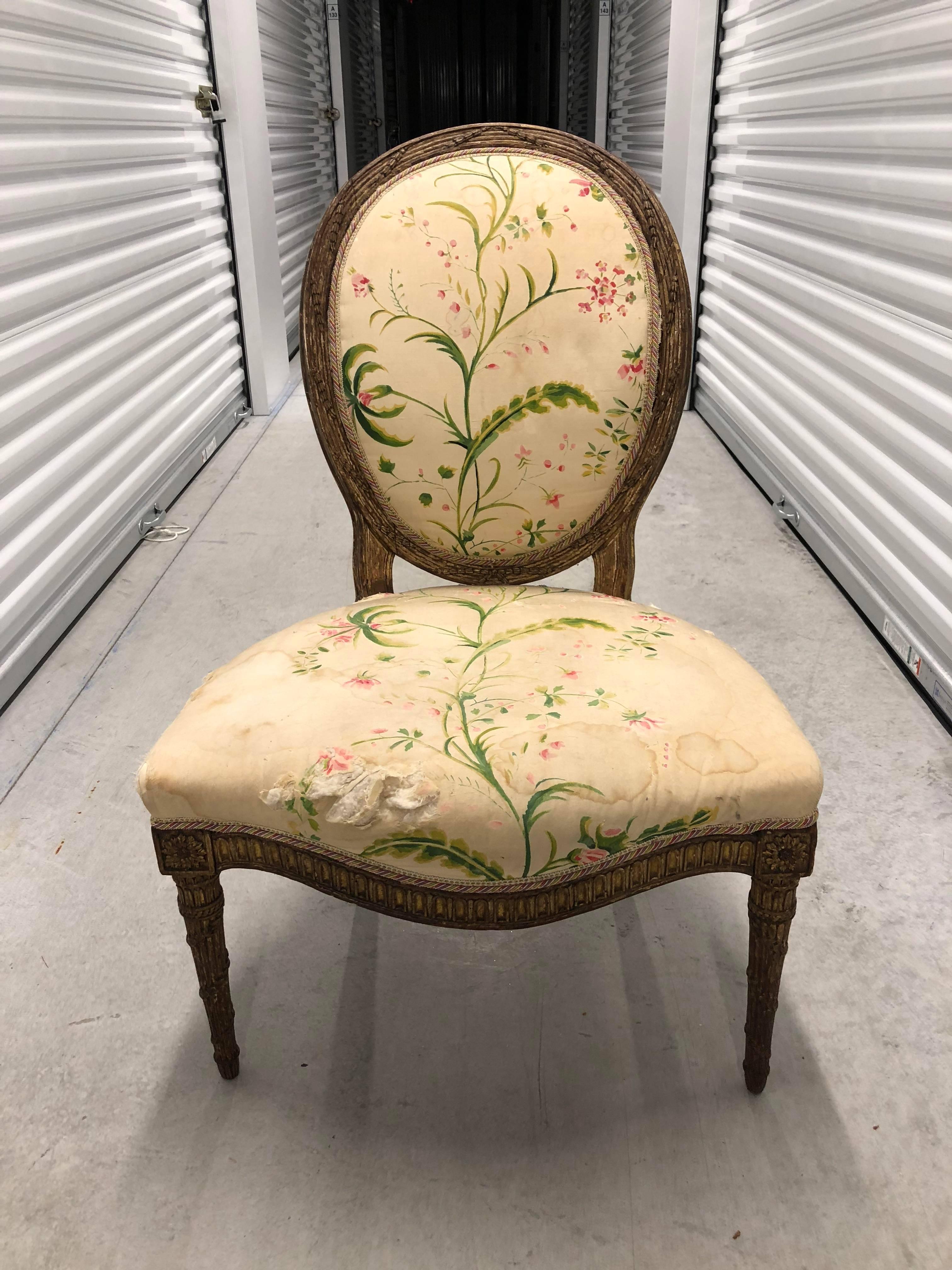 Louis XVI period carved giltwood side chair, circa 1775; French (or possibly English in the French taste); oval back, serpentine front, upholstered seat raised on turned and foliage carved frontal legs.