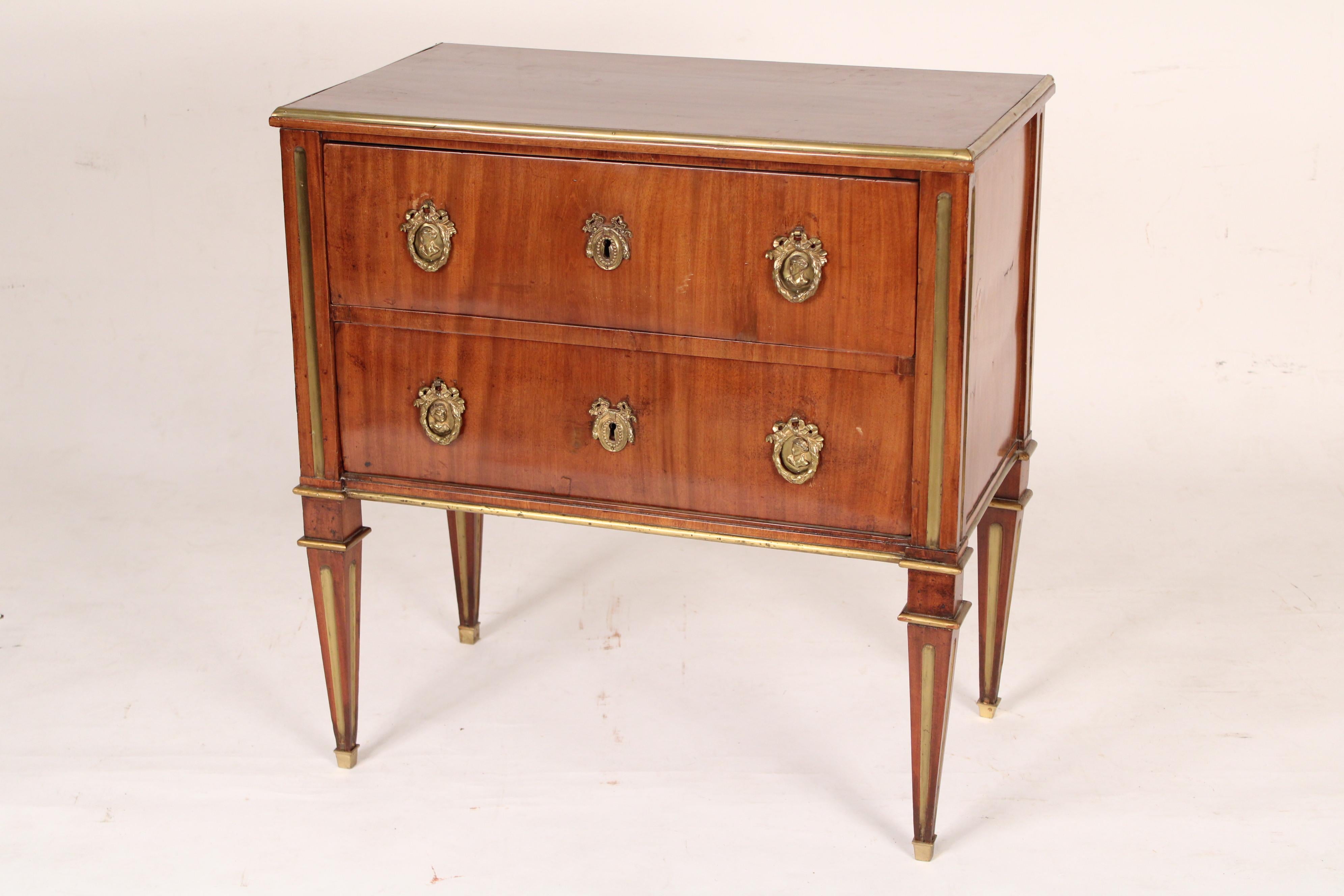 Russian or Swedish Louis XVI mahogany chest of drawers with brass inlay, circa 1800. Having a rectangular top with thumb molded brass borders, two grain matched drawers, resting on four square tapered legs with brass inlay.