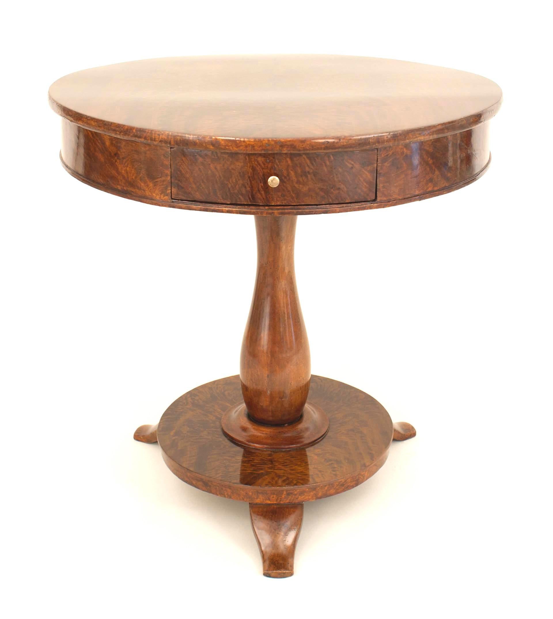 Continental (possibly Baltic) 19th century mahogany end table with a round top having a single drawer resting on a pedestal base over a round platform with 3 feet.