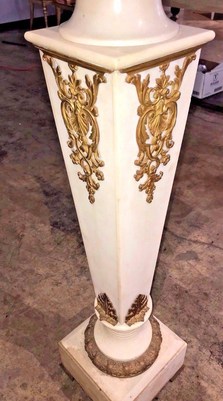 Gorgeous antique Continental white marble and gold-gilded bronze appointed pedestal. 

The square top rests above a highly detailed dore bronze Corinthian style capital and a tapered column adorned with gold-gilded bronze stylized leaf spray and