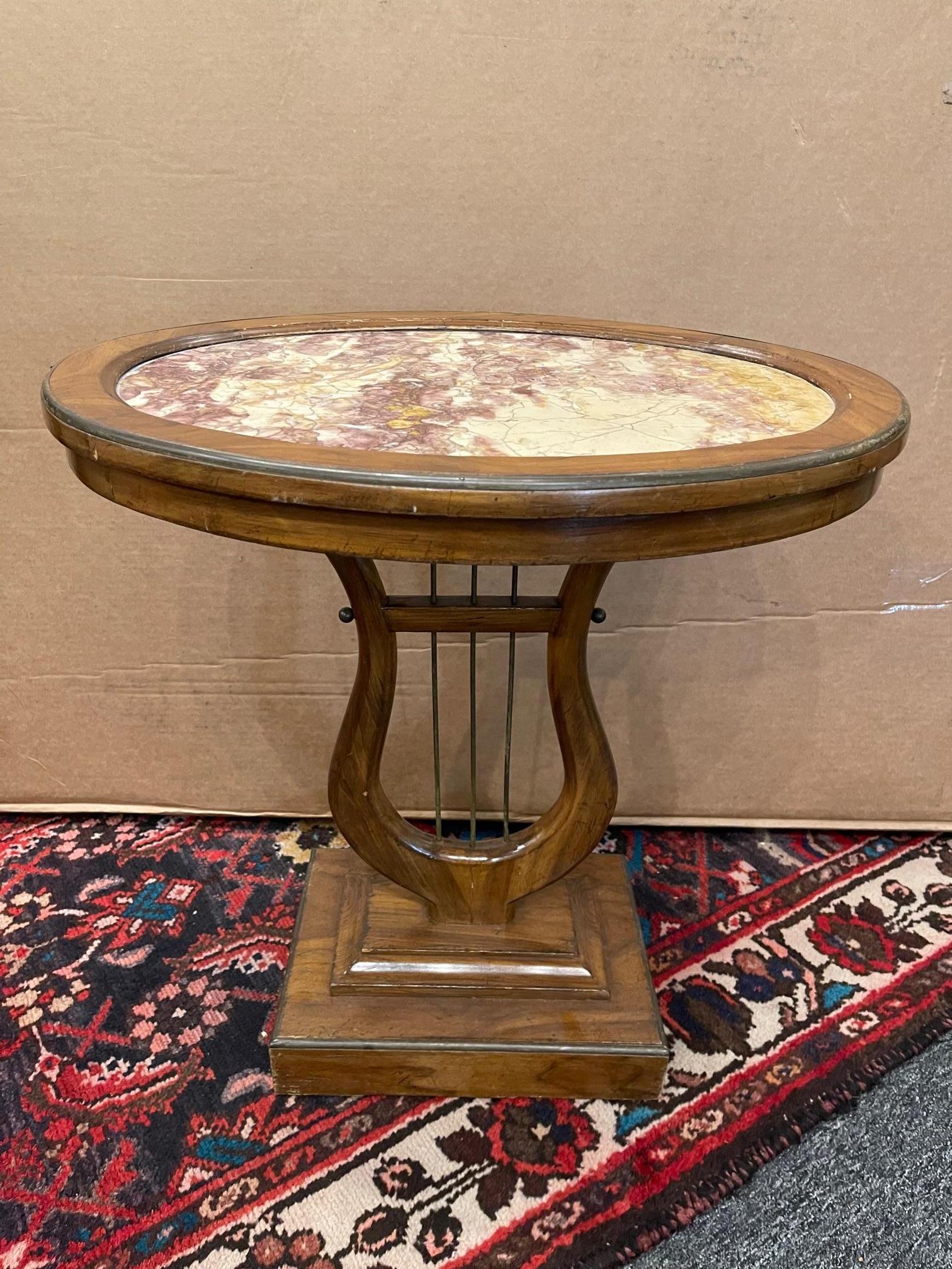 Continental marble-top side table in the shape of a lyriform, early 20th century. Measures: 22 1/4 x width 21 x depth 16 7/8 inches.
 