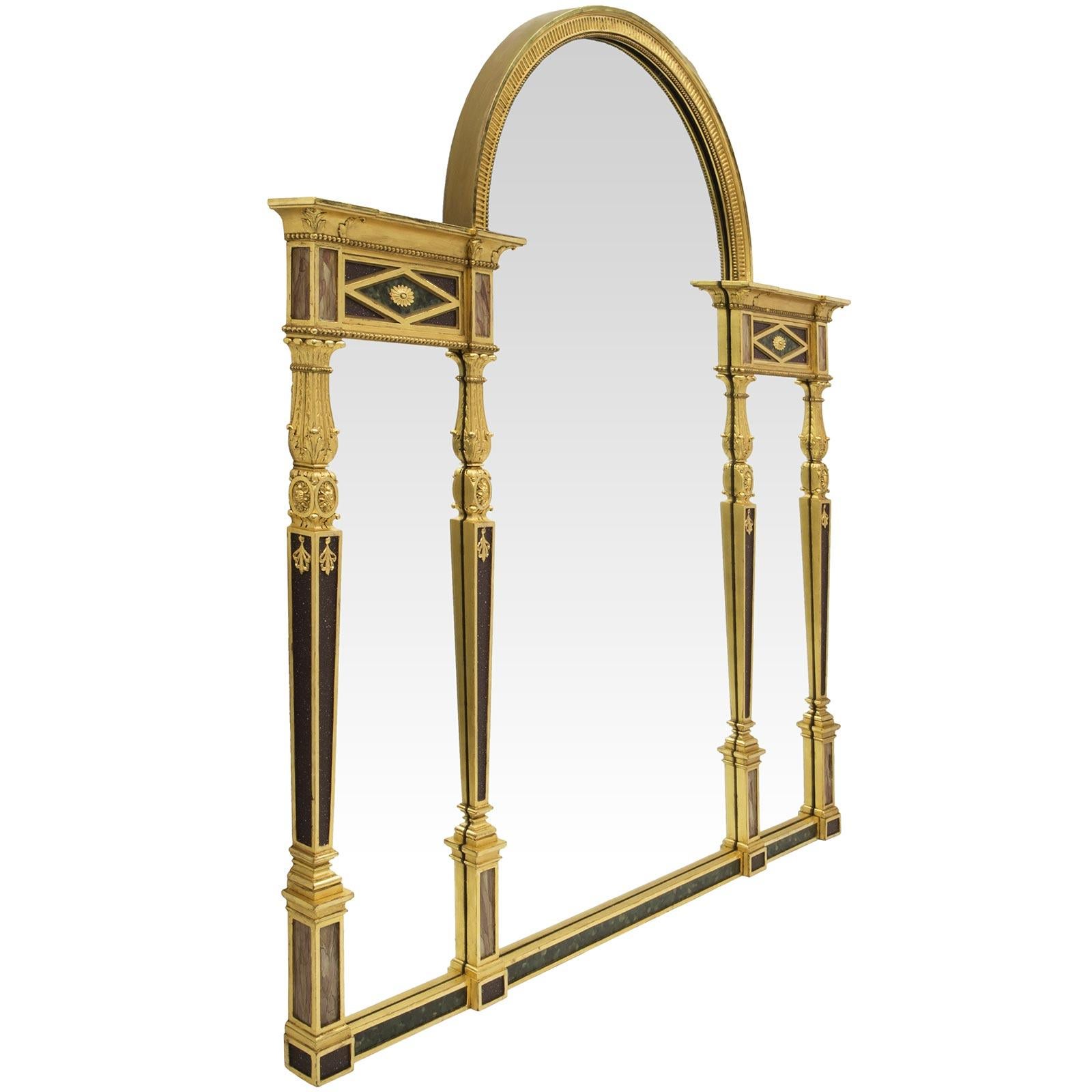 A sensational and unique Continental mid 19th century Neo-Classical st. painted and gilt, three panel mirror. The giltwood frame is designed with four vertical columns separating the three mirror plates. The tapered columns have recessed panels with