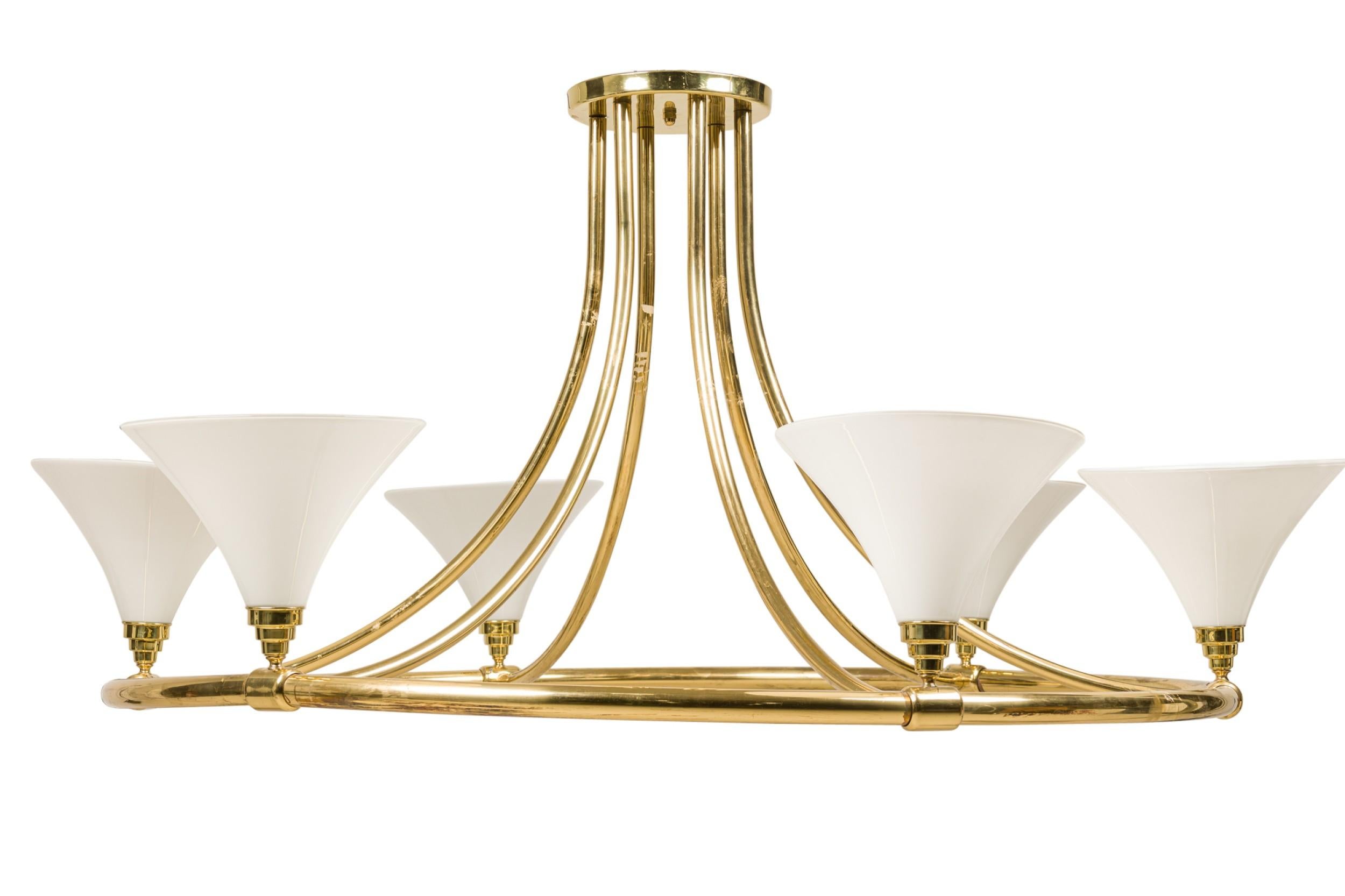 Continental Mid-Century monumental circular shaped 6-light chandelier with a polished brass frame and 6 tulip-form white glass shades.