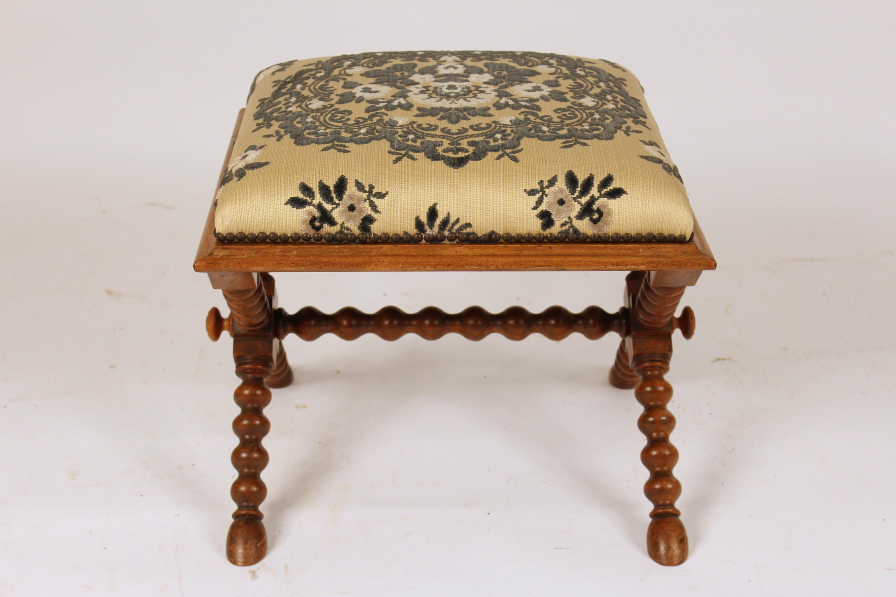 Continental Napoleon III style walnut bench, with turned legs ending in hoof feet, circa 1900.