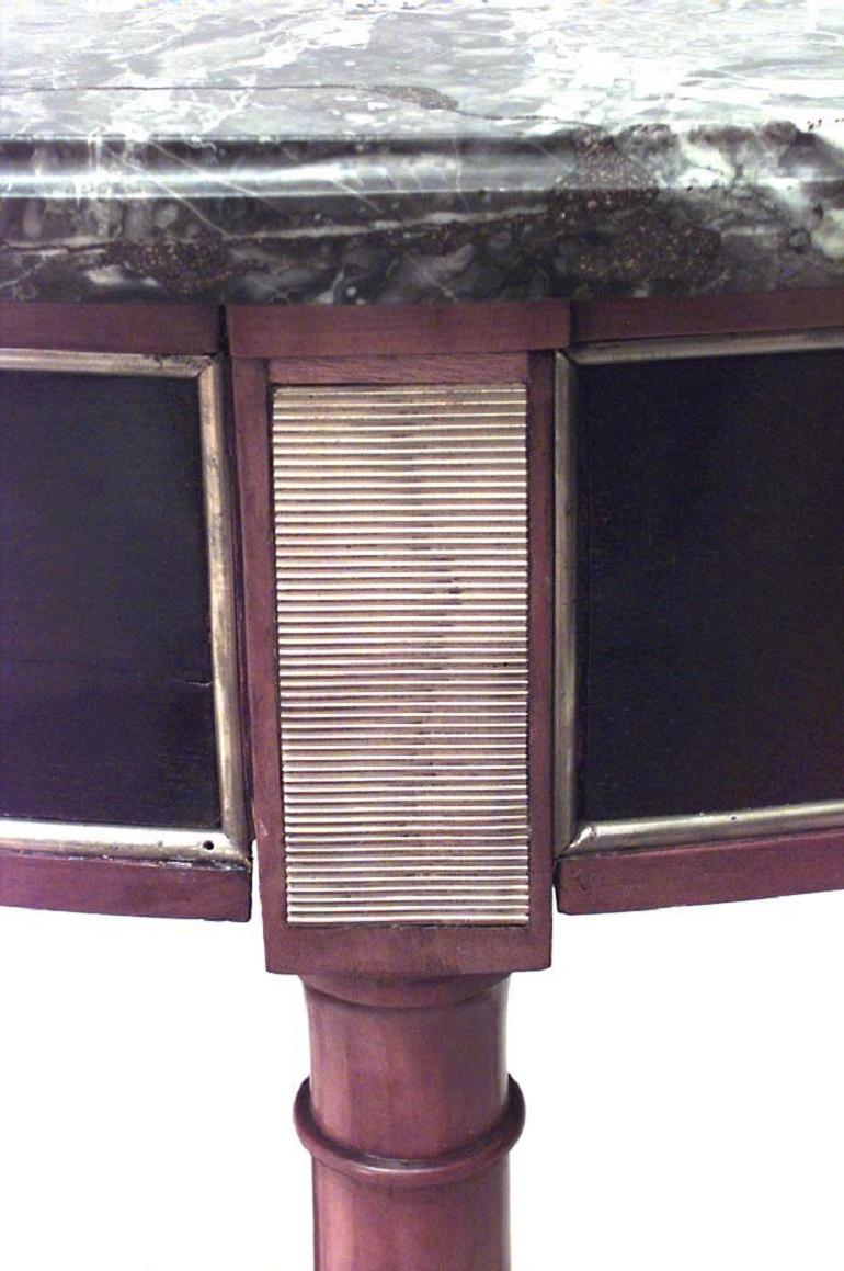 Continental Neoclassic (probably Russian 18/19th Century) brass mounted ebonized & fruitwood demilune console table with grey marble top above an apron and a shelf stretcher
