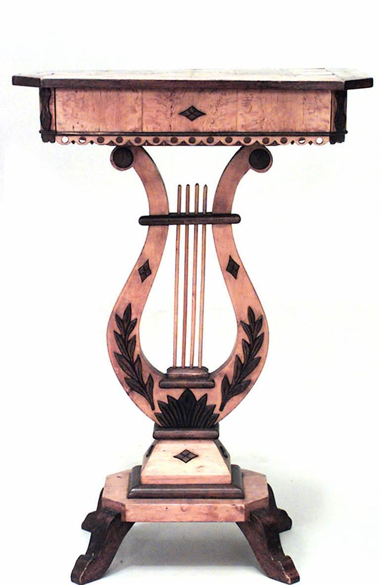 Continental Neoclassic Karelian (Circa 1820 and later embellished) birch, mahogany & parquetry side table with a frieze drawer on a lyre form stem.
