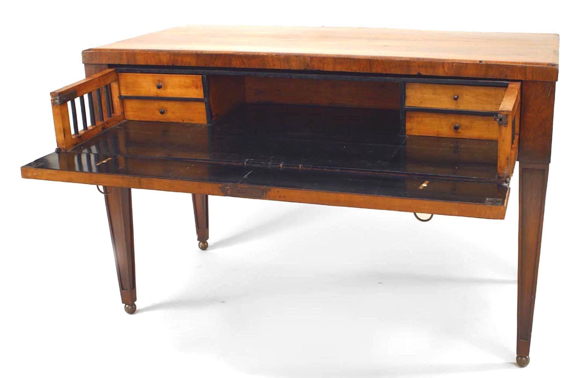 Continental neoclassic walnut writing table with fall front fitted secretaire drawer on replaced legs (early 19th century and later).
 