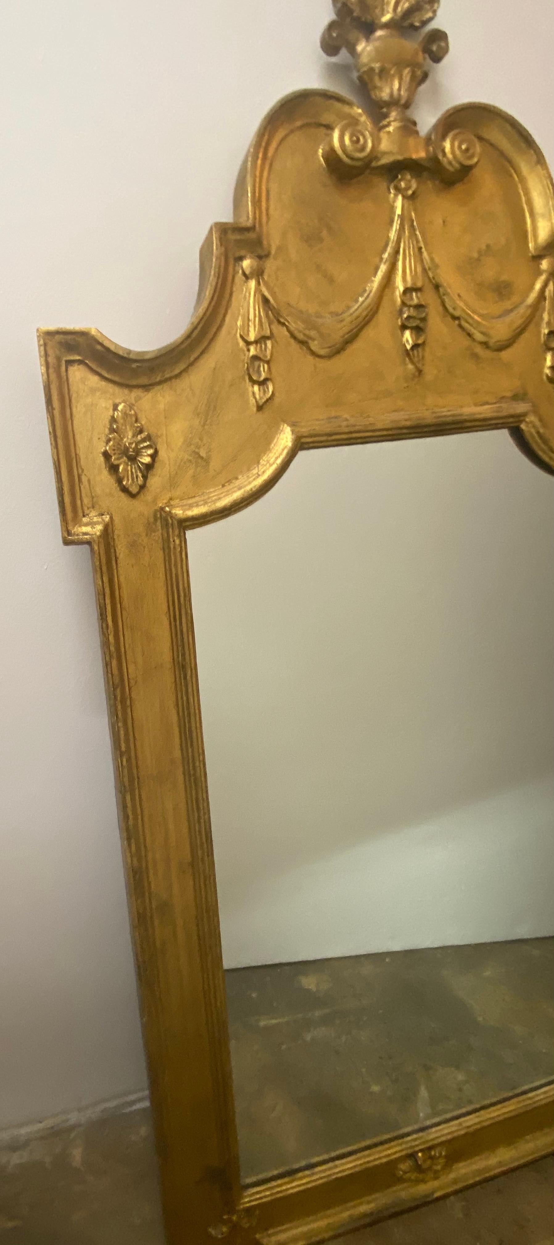 A Continental neoclassical style giltwood mirror.