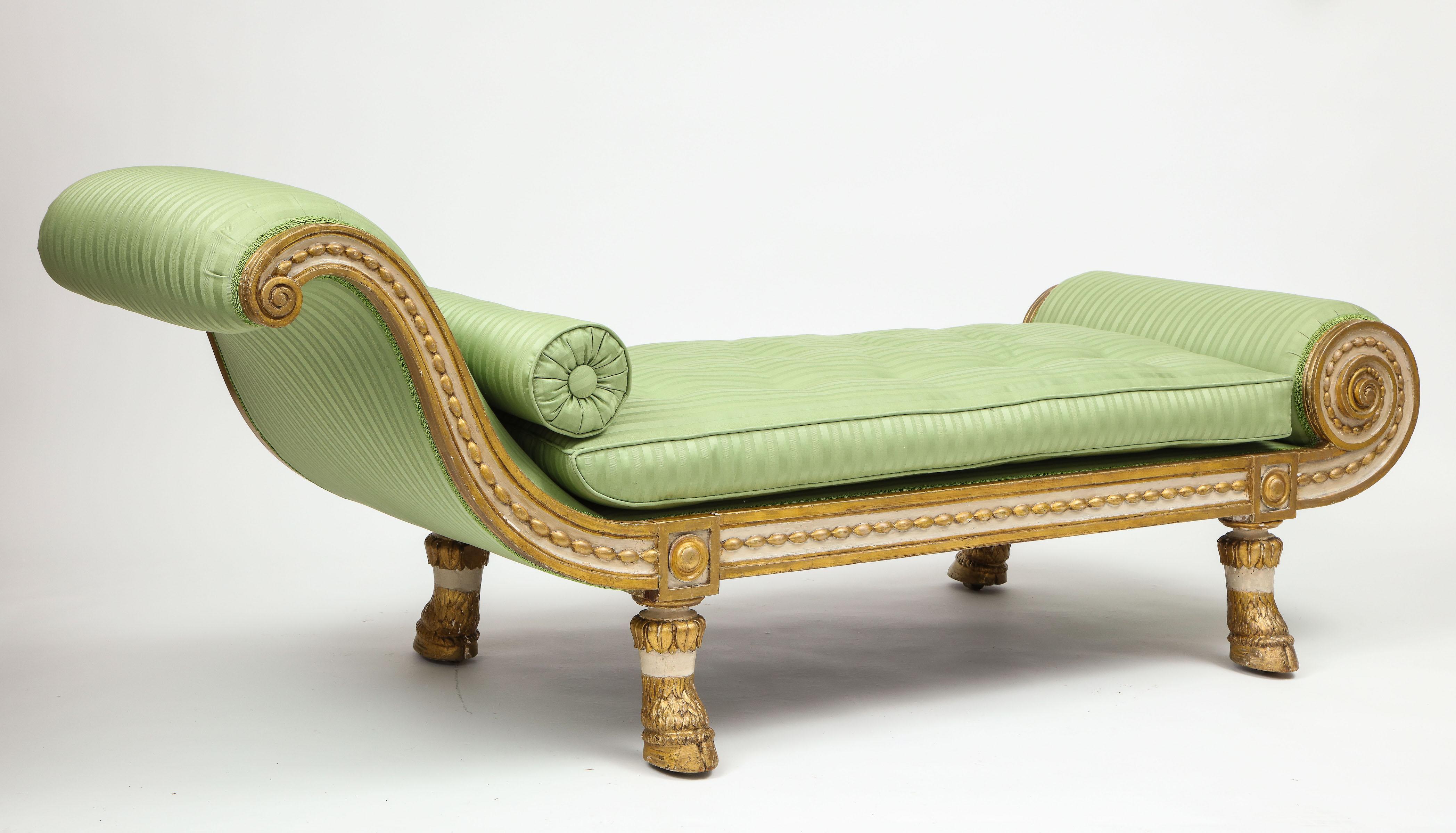With gracefully scrolling back and foot, upholstered in lettuce green striped silk, with ivory-painted frame embellished with gilt pearl decoration; raised on boldly carved pied-de-biche.