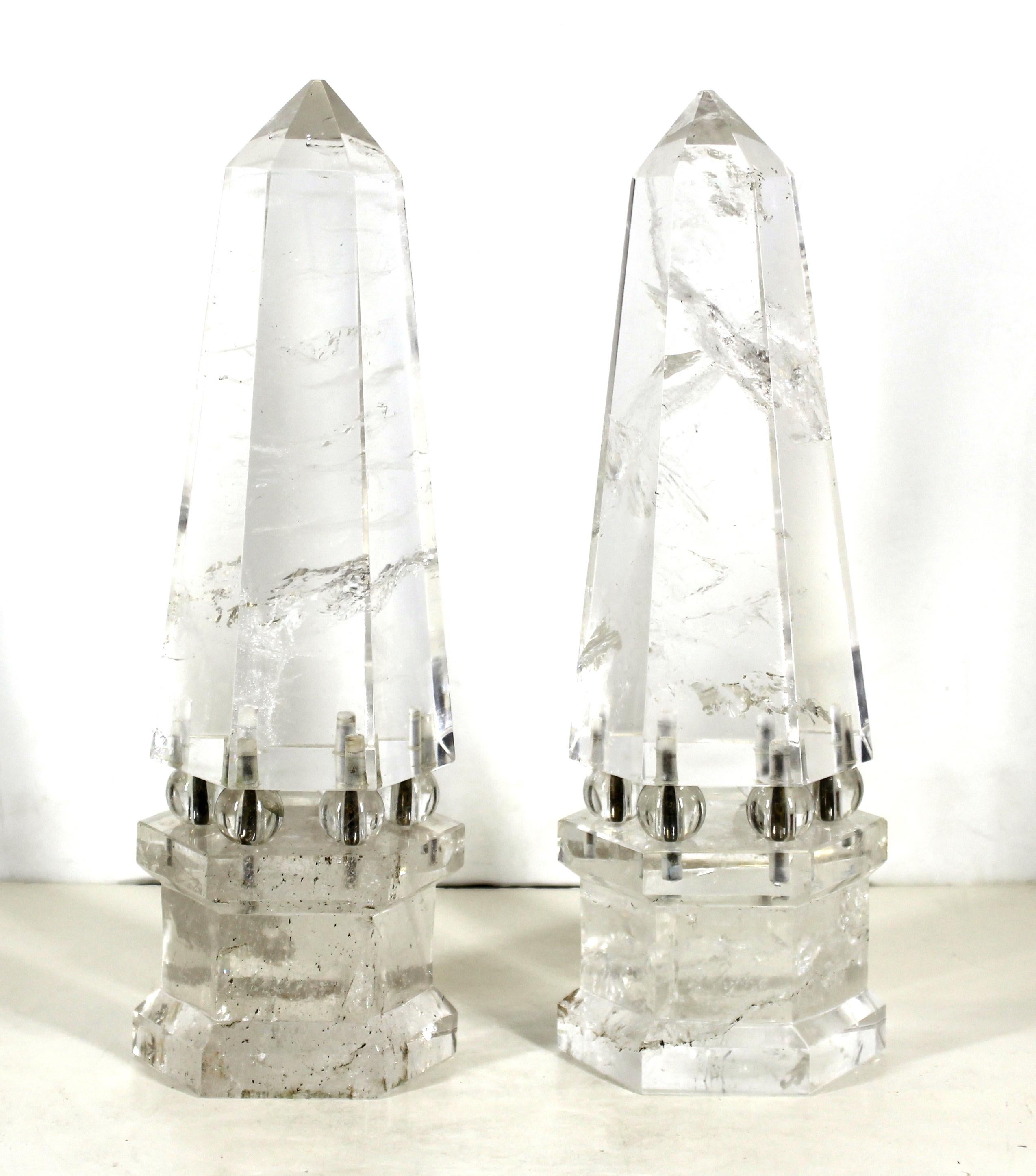 Continental neoclassical pair of rock crystal obelisks in hexagonal shape, each mounted on six bronze rods holding rock crystal balls and connecting to the hexagonal rock crystal base. Made in Europe during the early 20th century, the pair is in