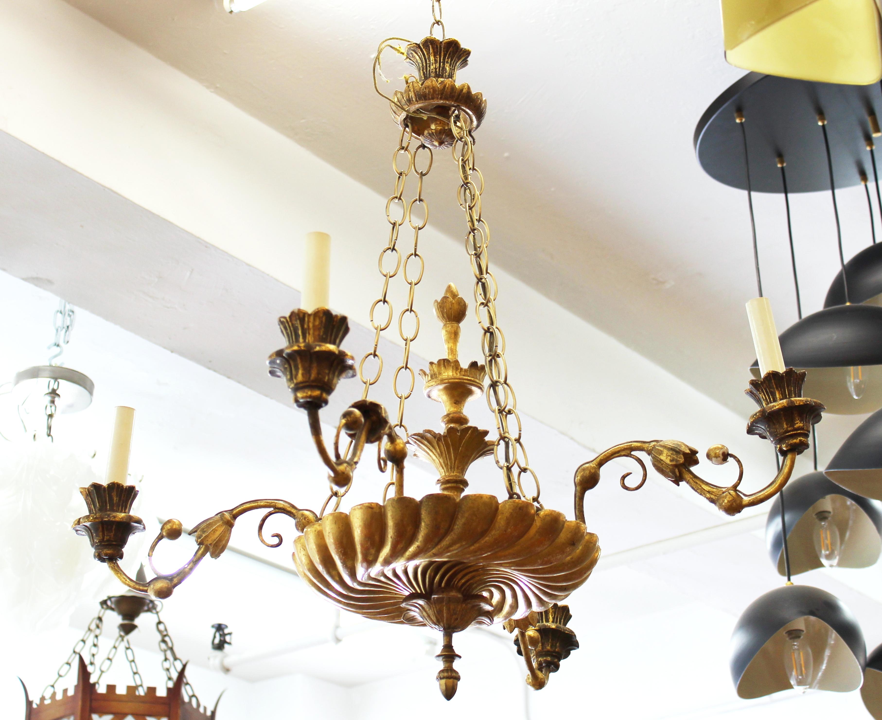 Continental Neoclassical revival style giltwood chandelier with ornamental floral elements.